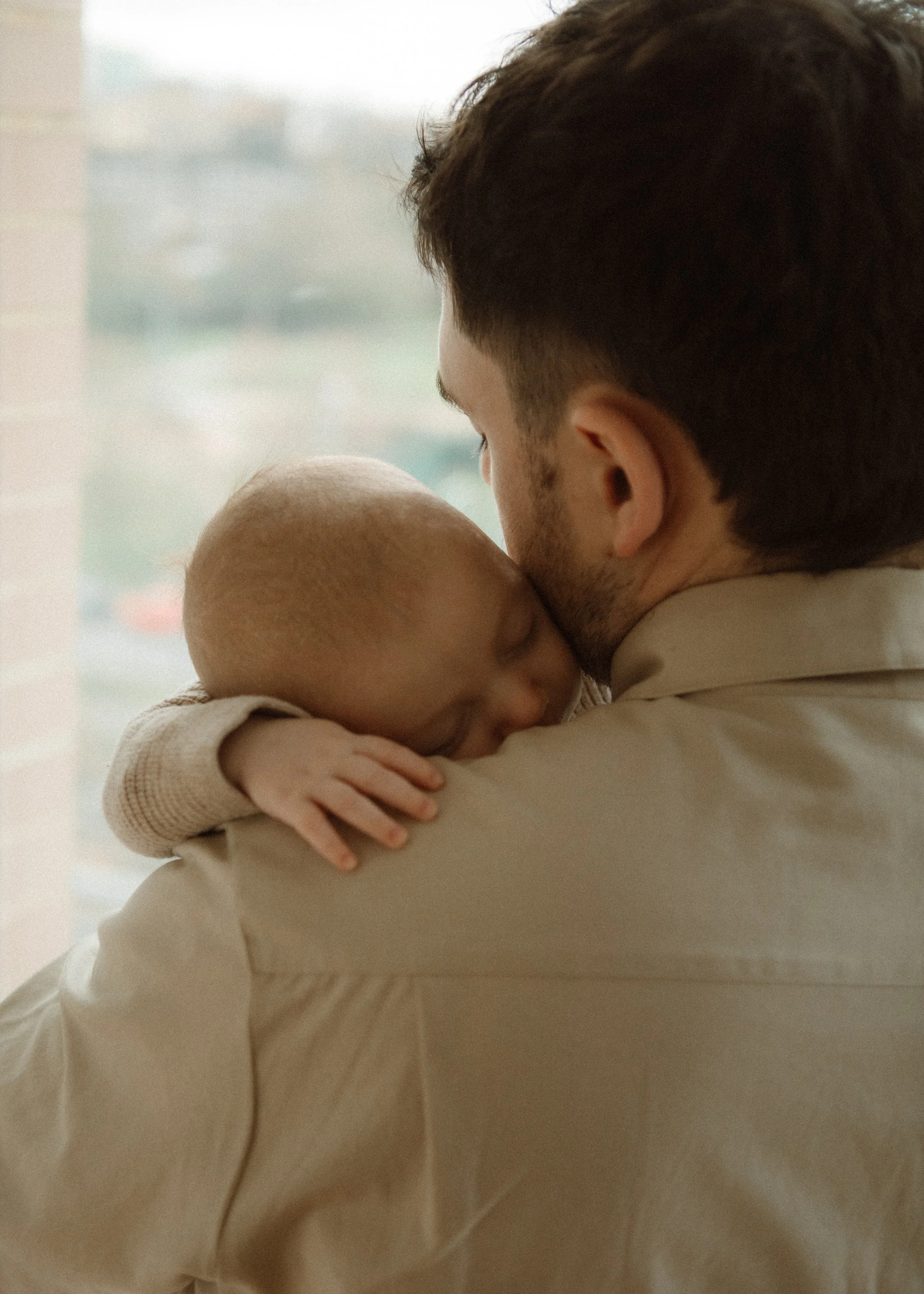 Mother with newborn baby and child during in-home family session, Southeast London