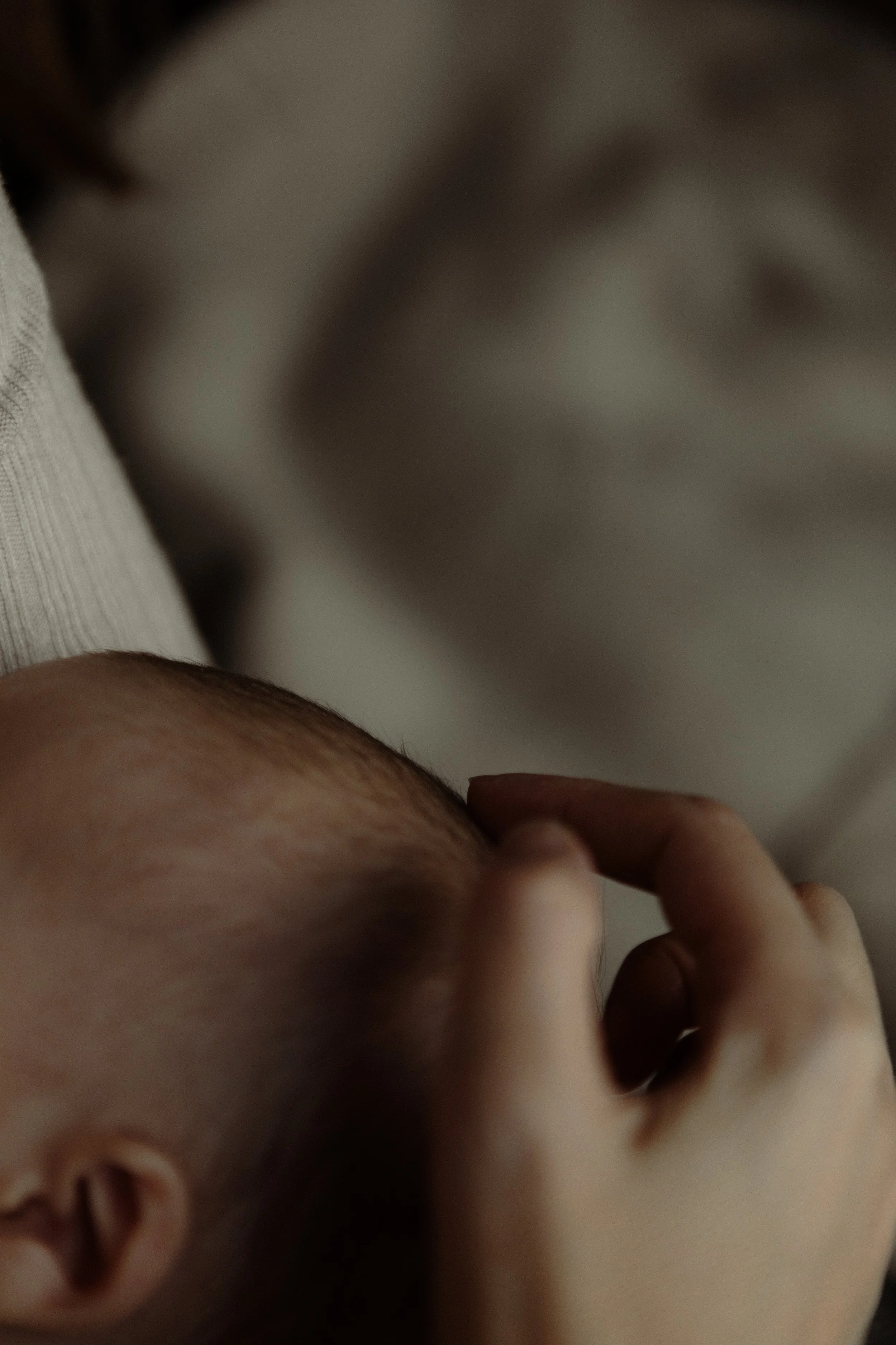 Mother with newborn baby and child during in-home family session, Southeast London