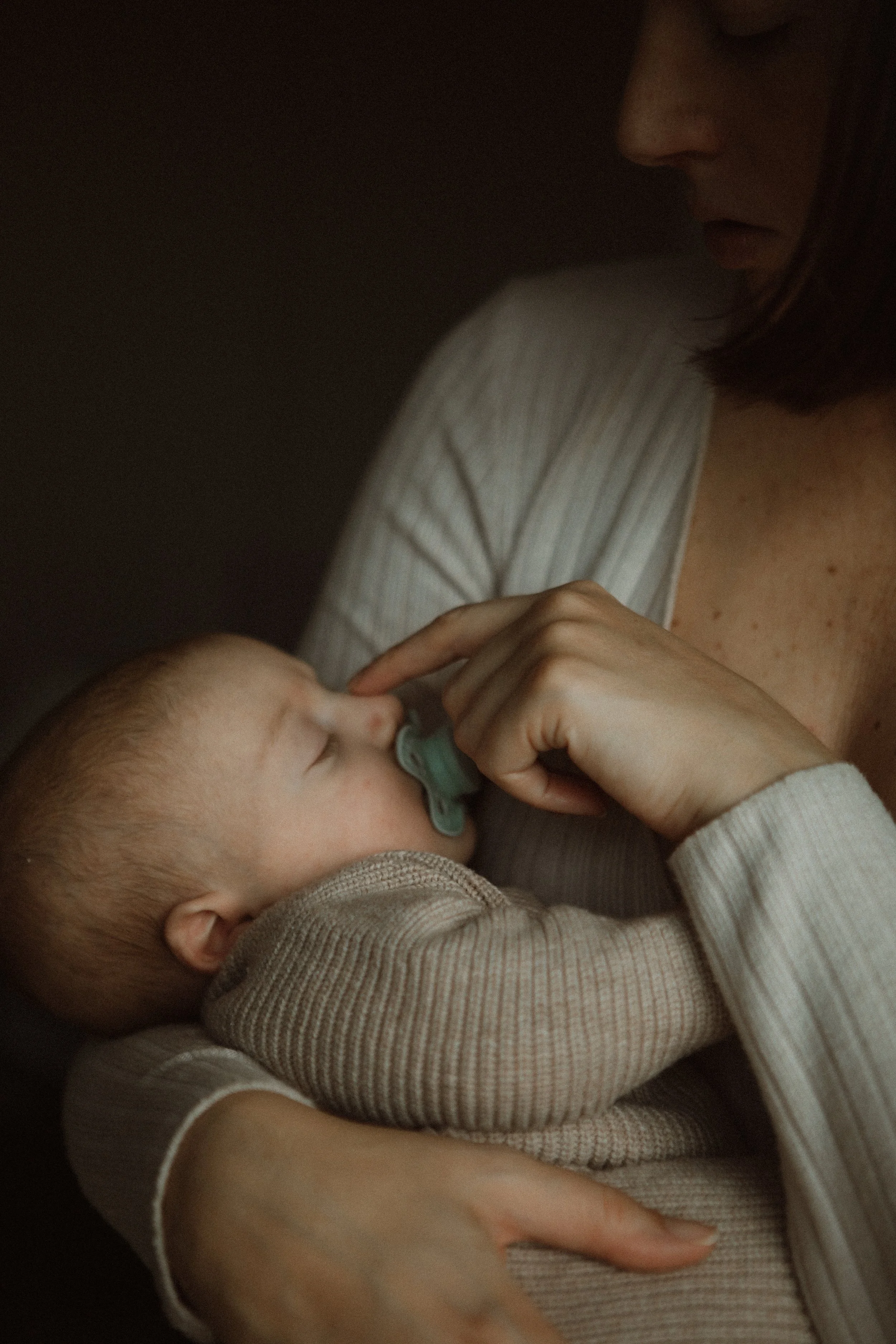 Mother with newborn baby and child during in-home family session, Southeast London