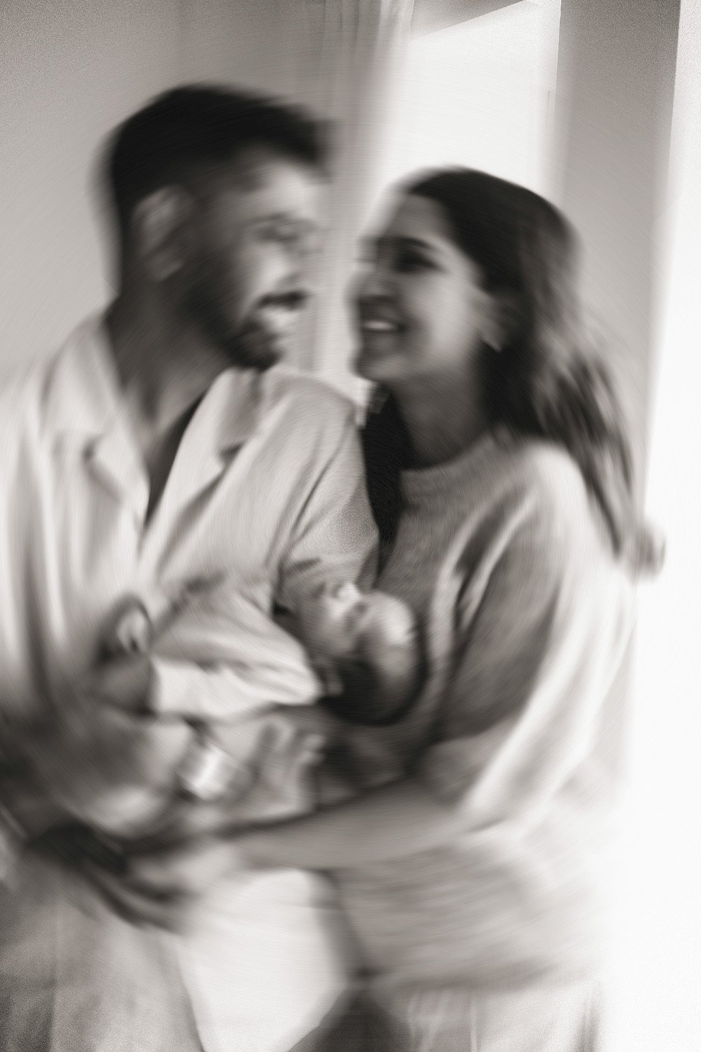 Natural warm Lifestyle image of mum, Dad and their brand New baby in their North London home