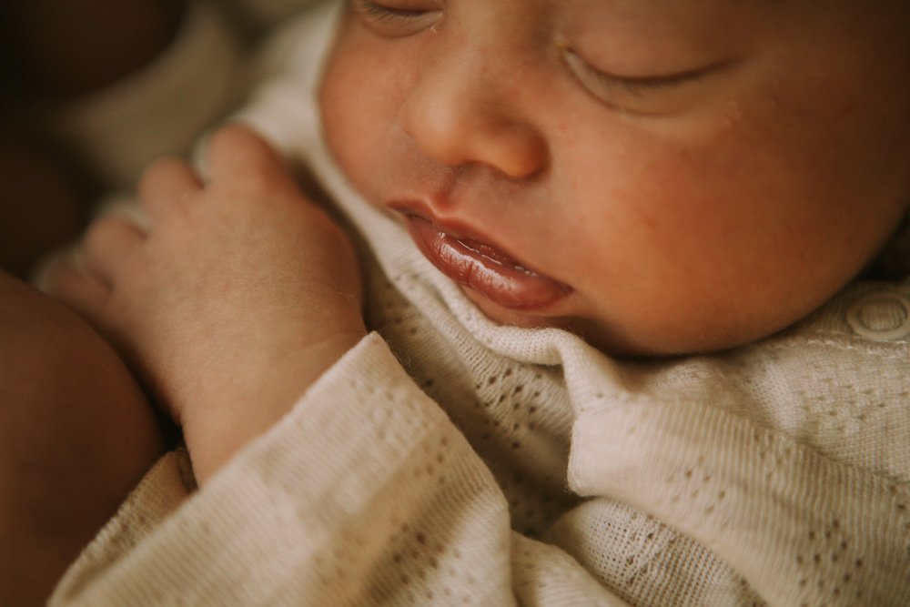 Newborn’s tiny lips in soft natural light — intimate London newborn portrait.