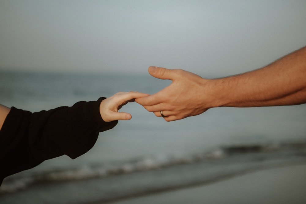 Close-up of a couple’s hands touching, capturing a quiet moment of connection during a London photography session