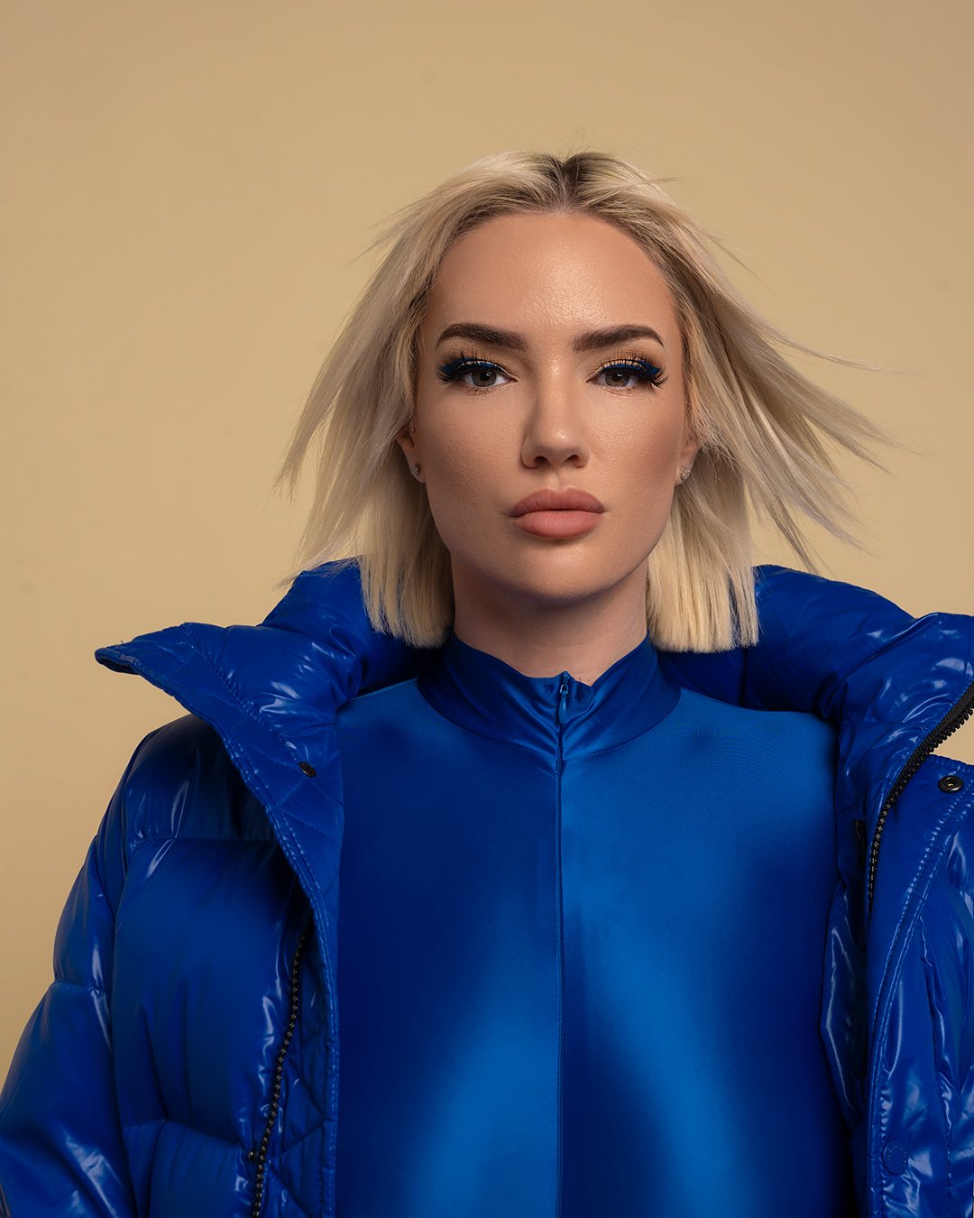 a blonde female model dressed in all blue