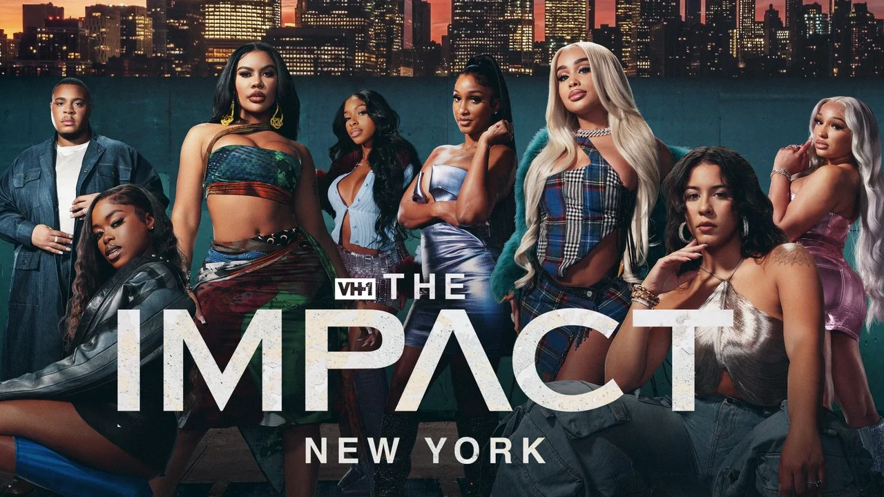 Group of women and one man posing against a city skyline at sunset with the text 'VH1 The Impact New York'