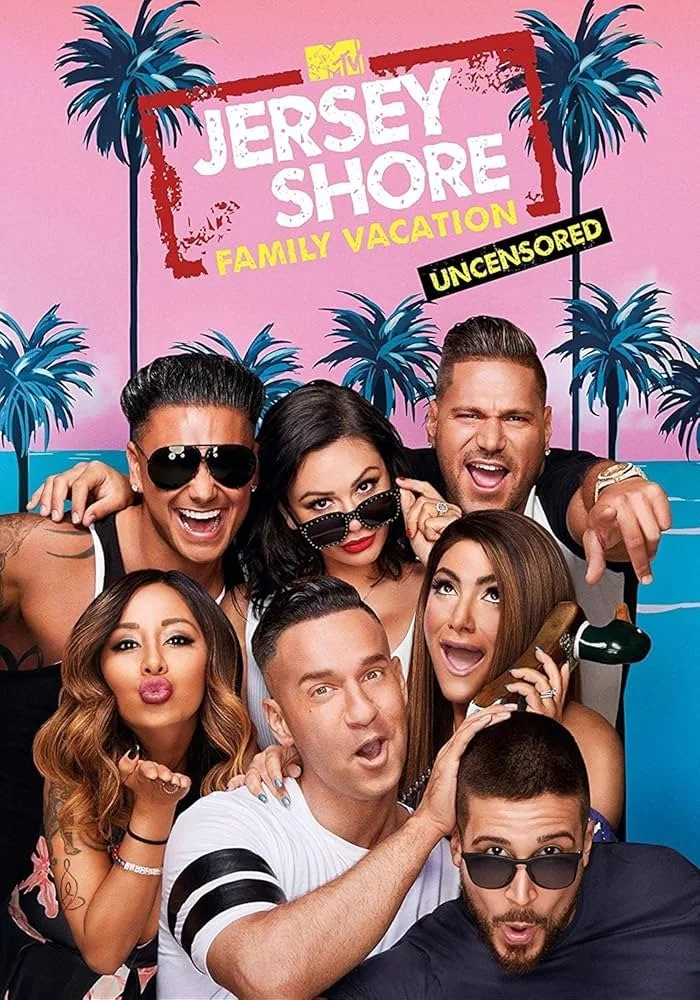 Promo poster for MTV's Jersey Shore Family Vacation featuring seven people, five men and two women, posing together, with a pink background, palm trees, and a sign that reads 'Jersey Shore Family Vacation Uncensored'.