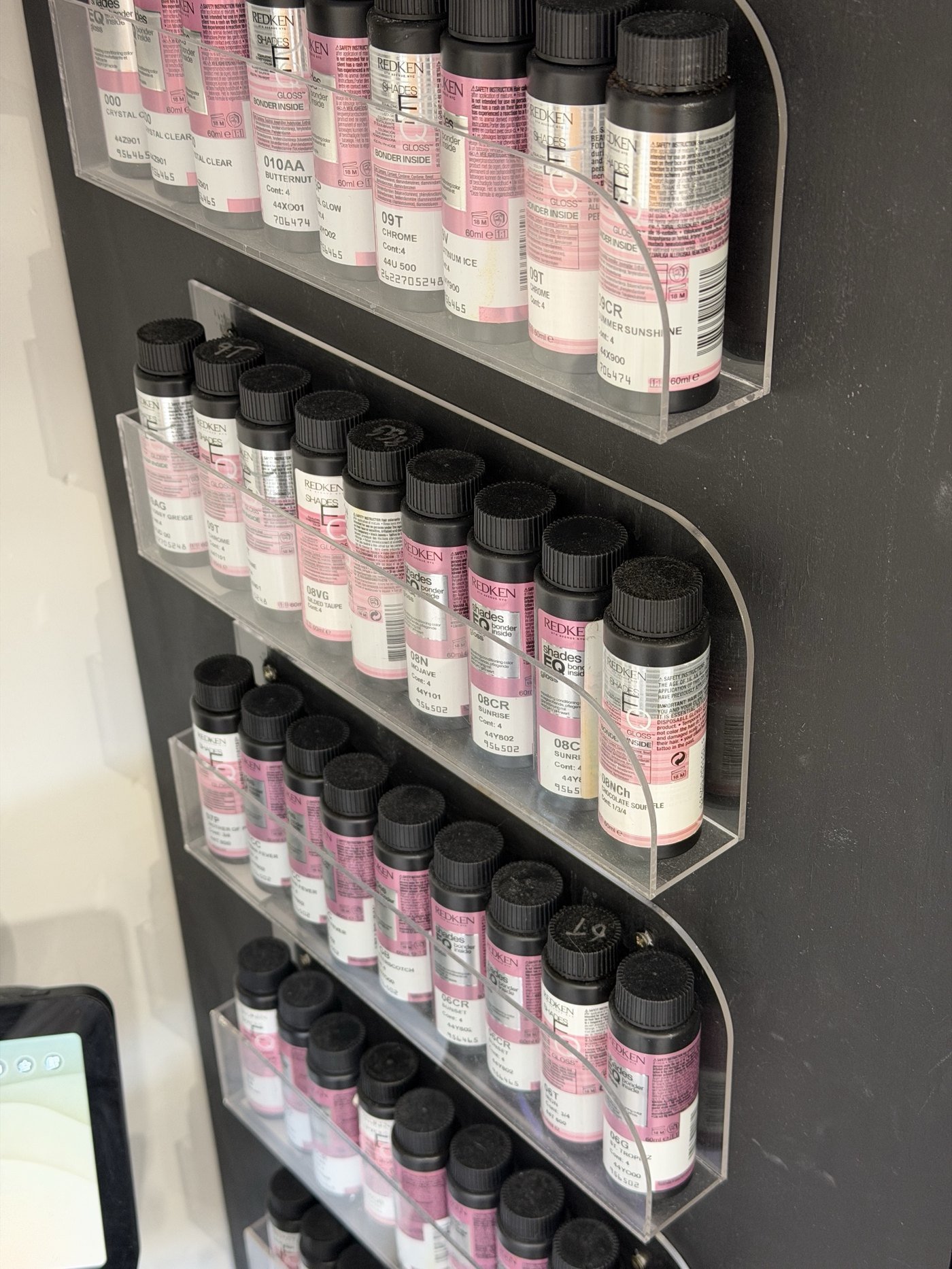 Gloss and toner shelf in Stephen William Hair's studio, used for grey blending refresh appointments in Waterlooville