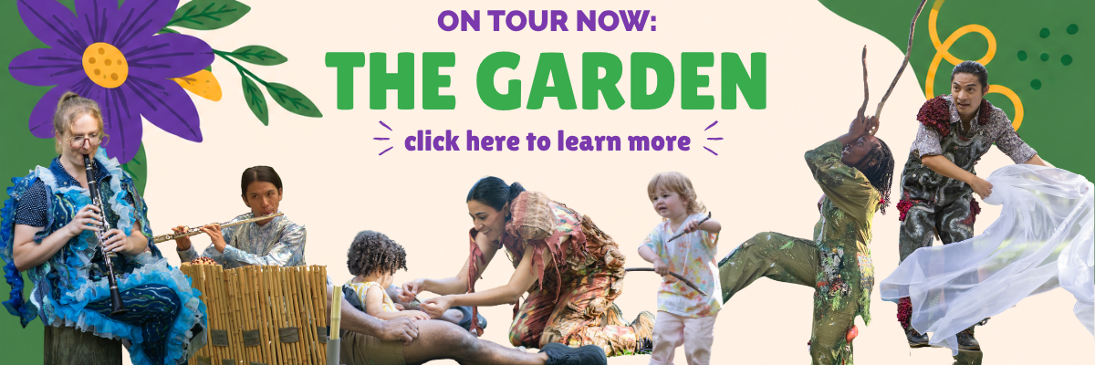 Musicians and performers in colorful costumes interact playfully with children, play instruments, and dance with sticks and fabric.