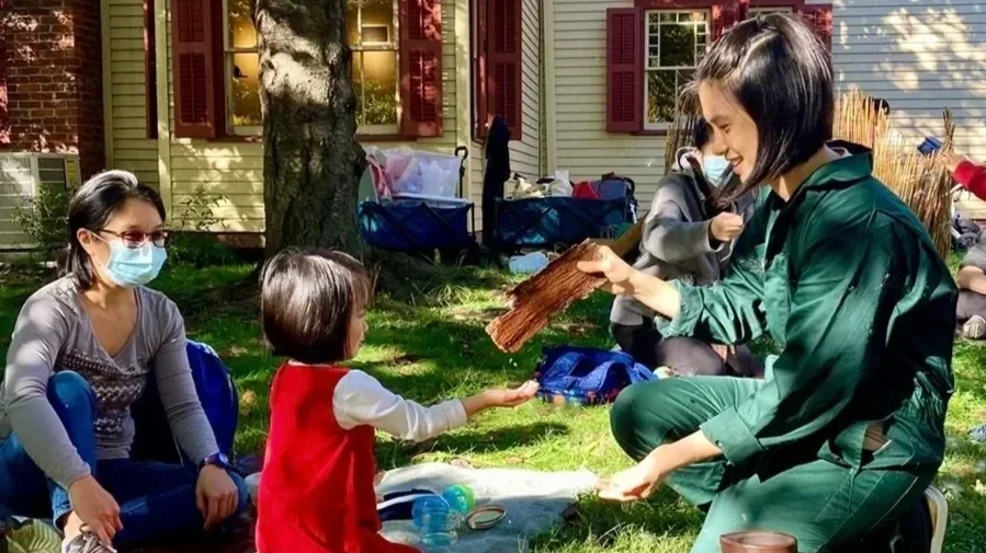 Child interactive with Flying Leap artist during performance of The Garden