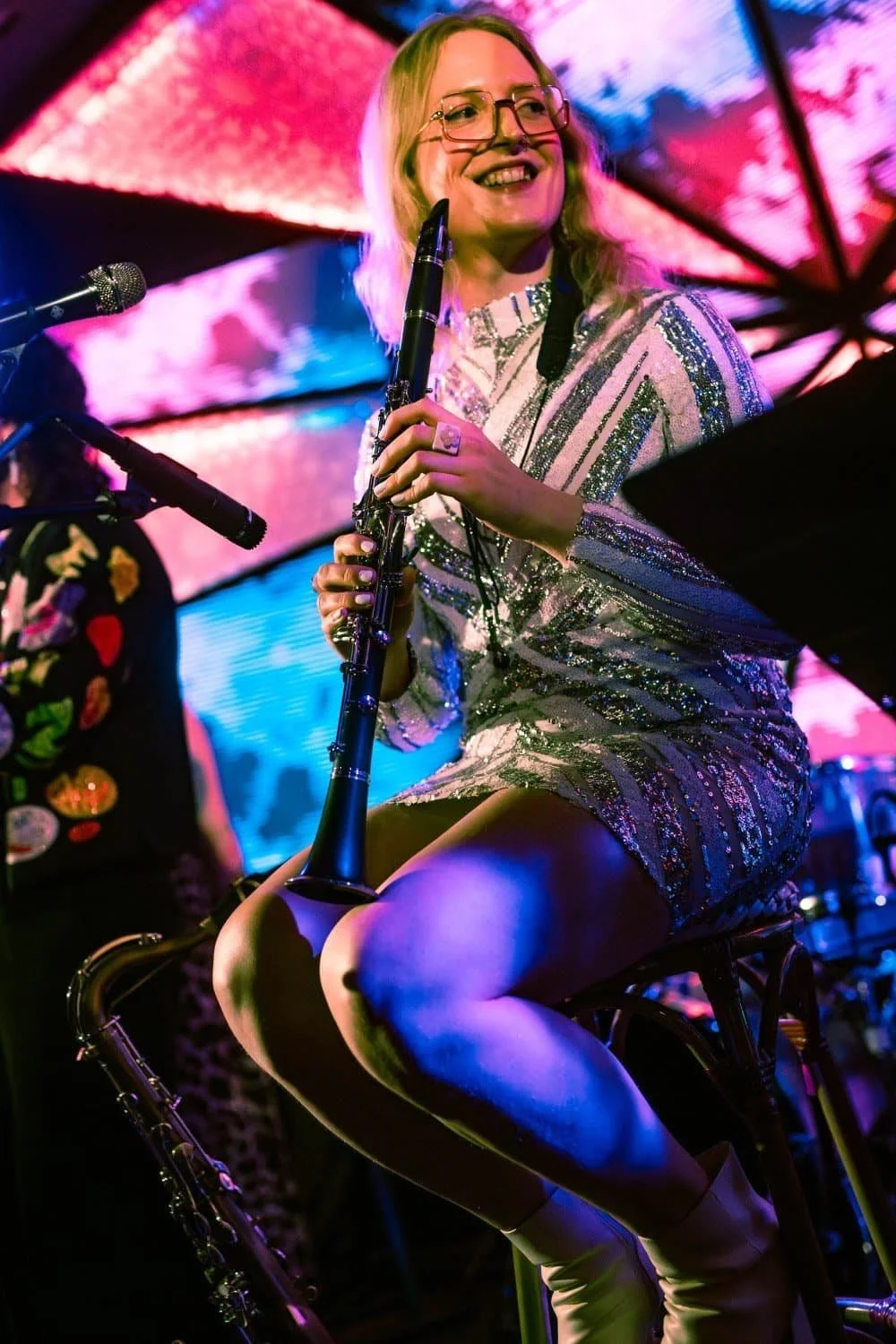 Betty playing clarinet in a shiny dress
