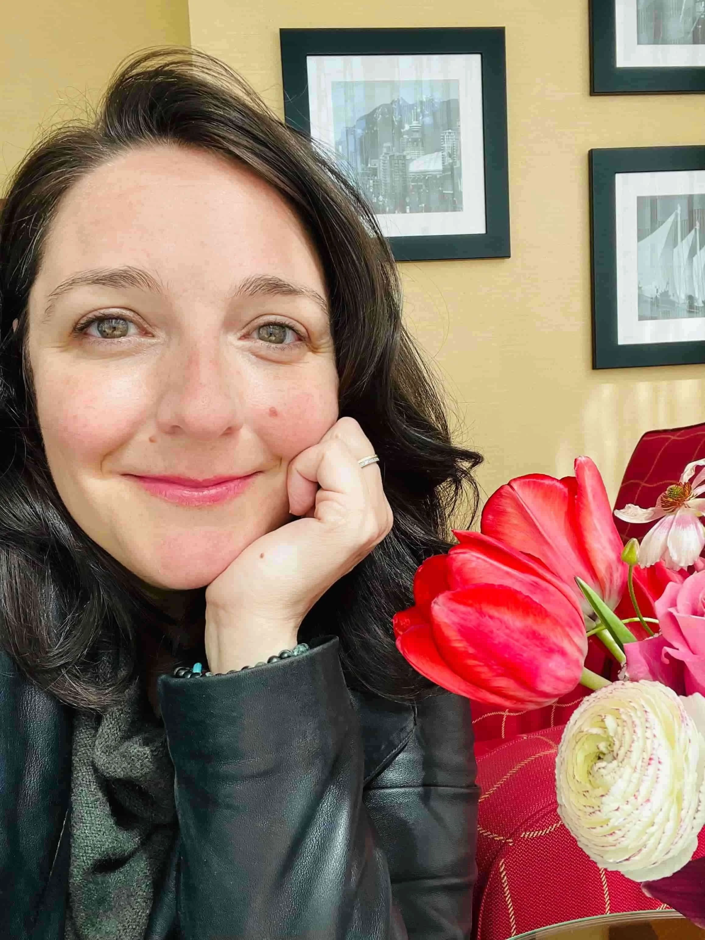 Photo of Carla Zanoni with a red flower