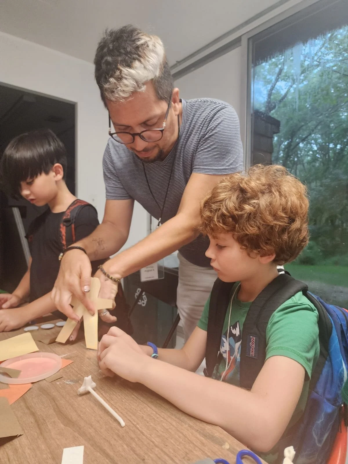 Oscar demonstrating a puppet to young child.