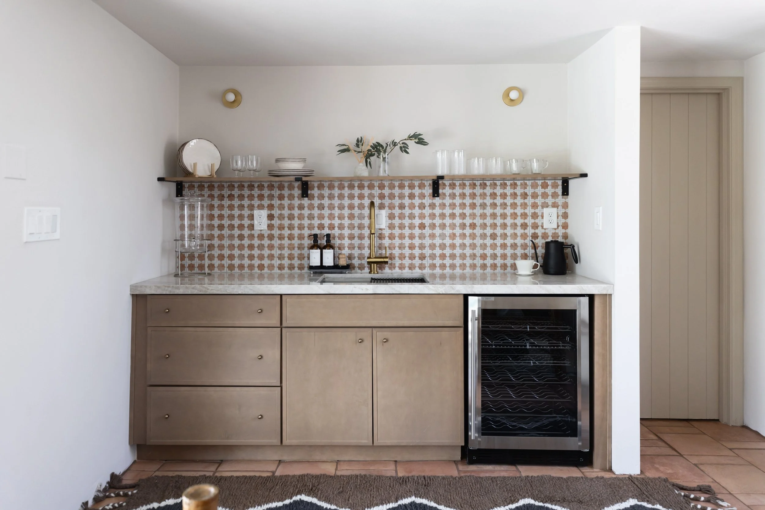 Desert modern casita kitchenette in a Tucson, Arizona guest house featuring warm wood cabinetry, natural textures, and a compact kitchen design perfect for a backyard casita retreat.