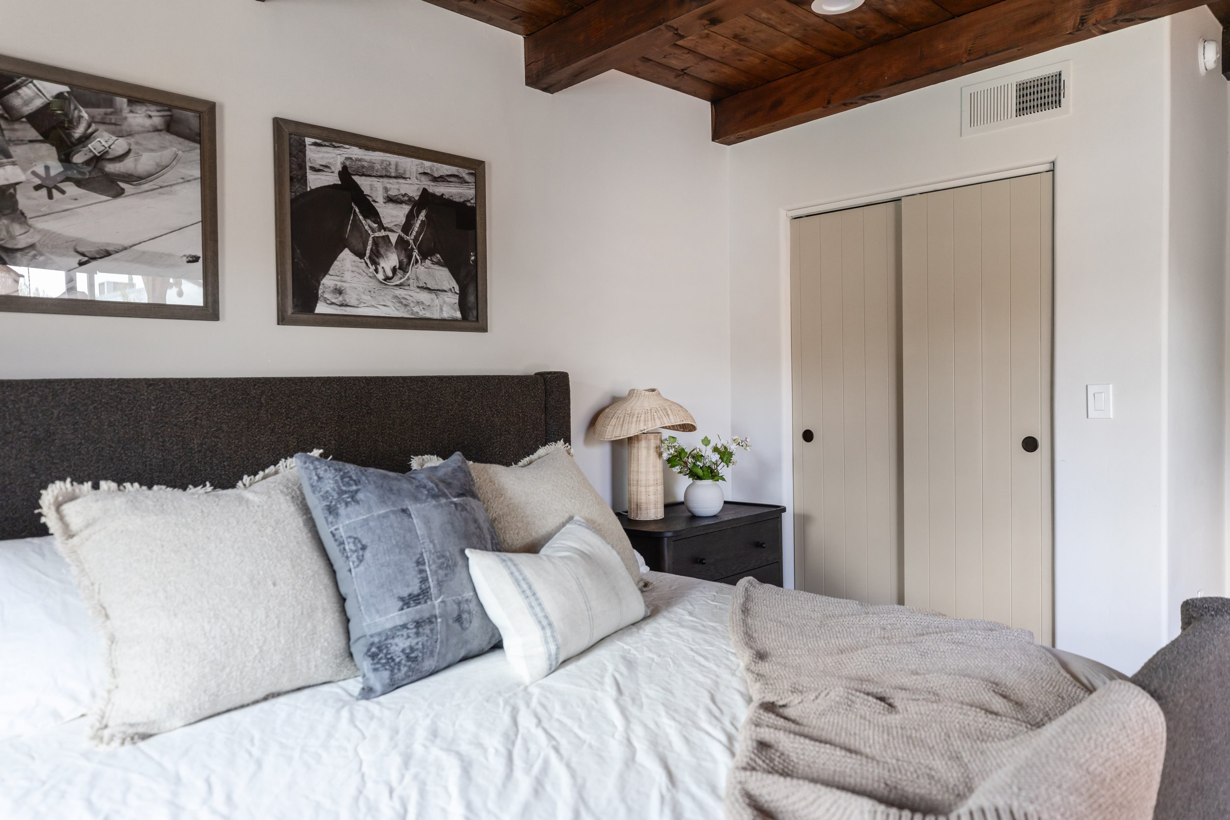 Serene primary bedroom in a renovated 1940s Tucson pueblo house with warm desert tones and modern Southwest styling.