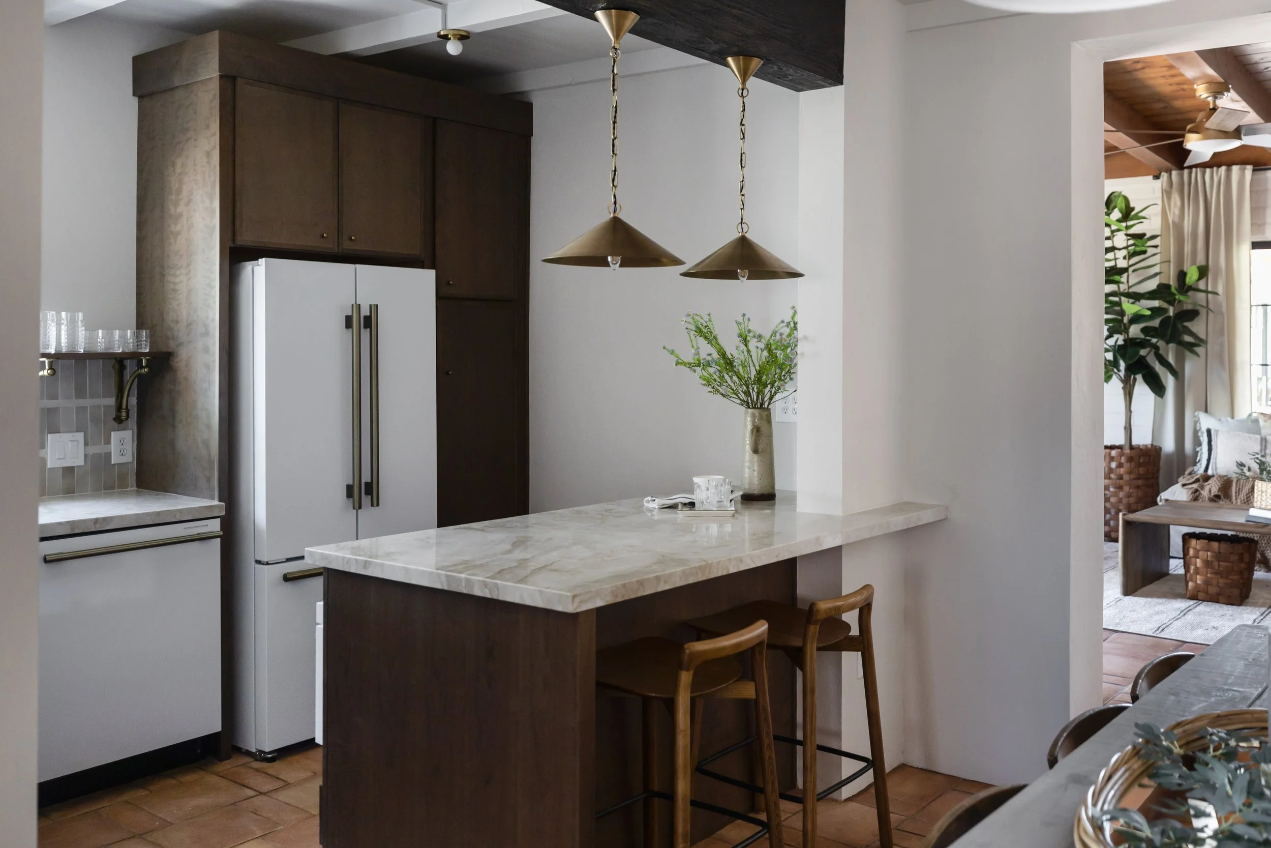 Modern desert kitchen in a renovated 1940s pueblo home in Tucson, Arizona featuring warm wood cabinetry, natural stone surfaces, and Southwest-inspired design.
