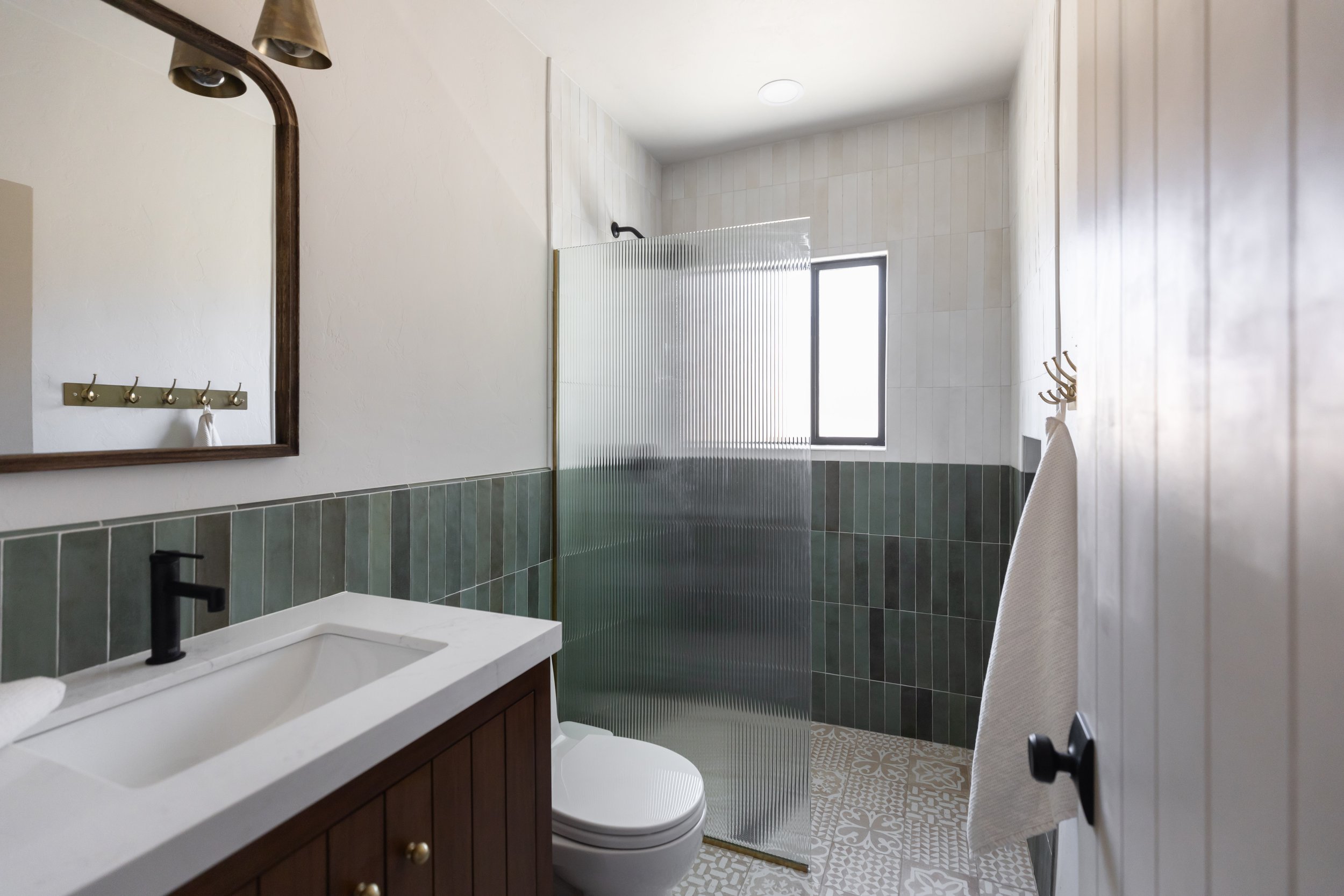Green bathroom design in a historic Tucson pueblo home featuring bold tile, natural textures, and modern Southwest interior styling.