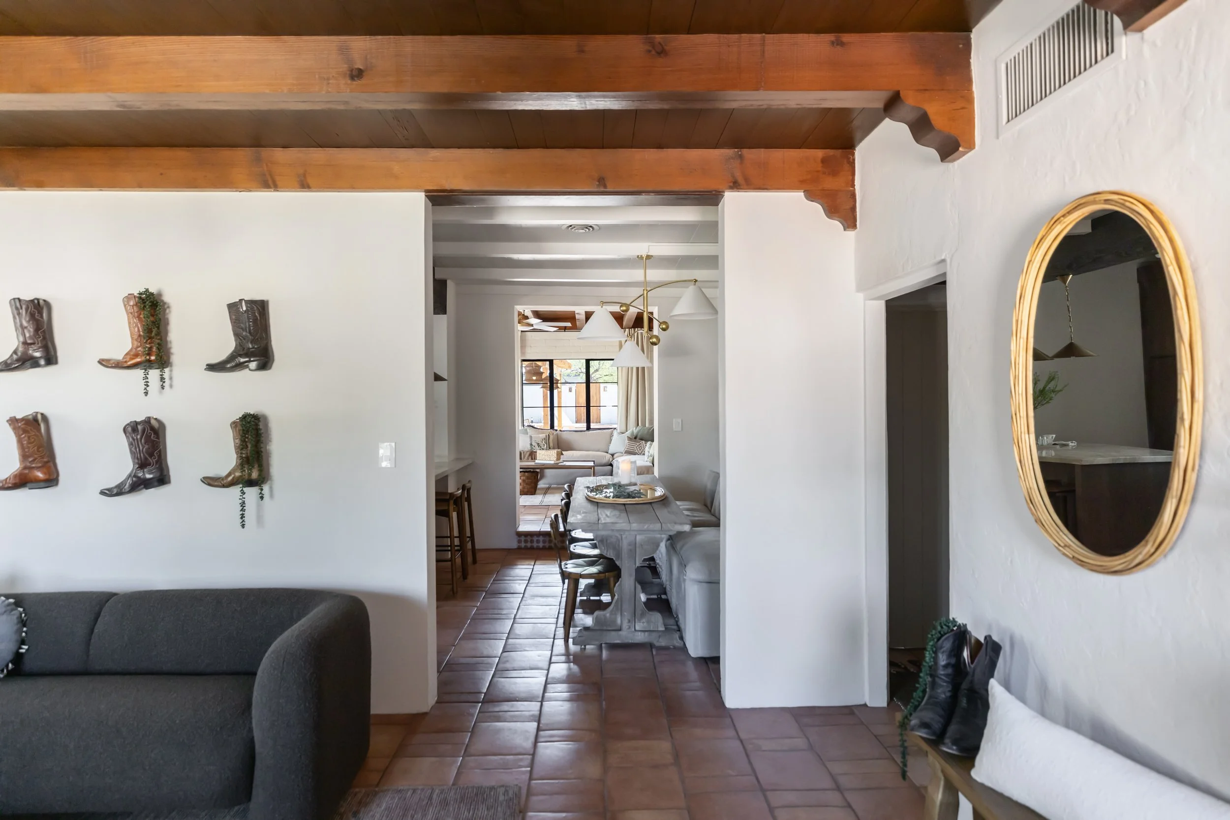 Renovated 1940s Tucson living room blending historic pueblo architecture with modern desert design, layered textiles, and comfortable seating.