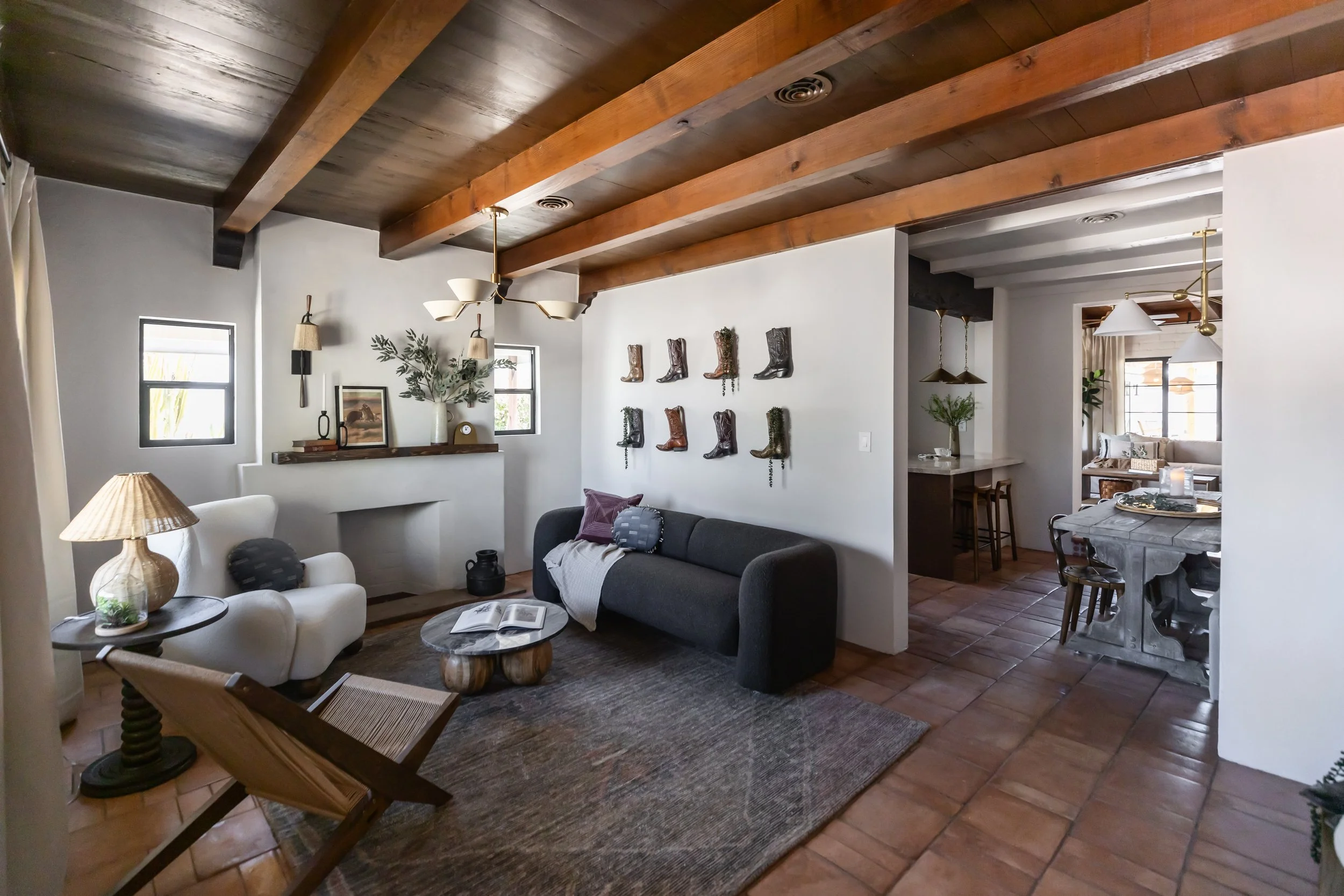 Historic pueblo home living room in Tucson, Arizona featuring modern Southwest interior design, warm neutral tones, natural textures, and restored architectural character.