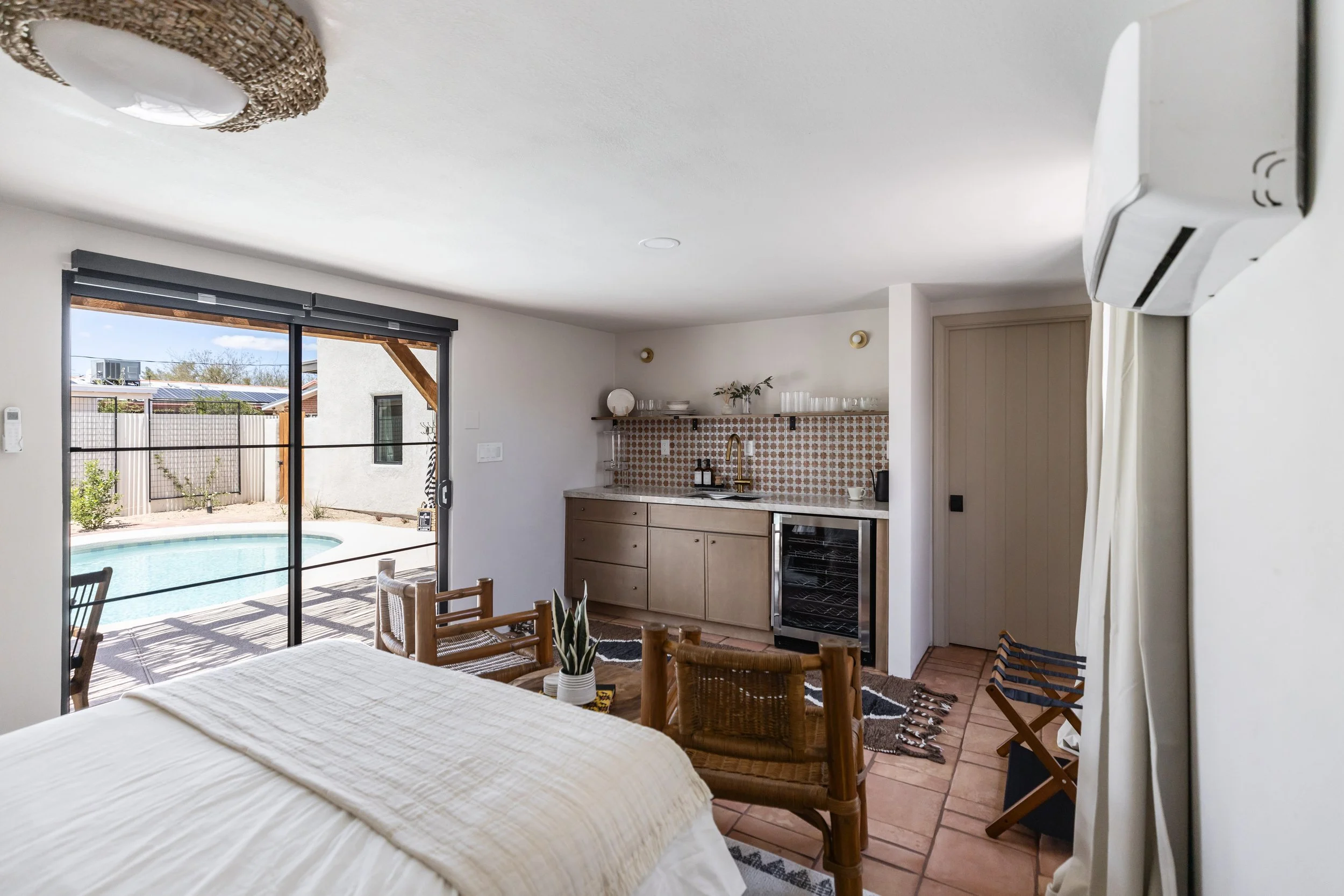 Desert modern living room inside a renovated Tucson backyard casita with cozy seating, layered textures, and warm desert-inspired materials.
