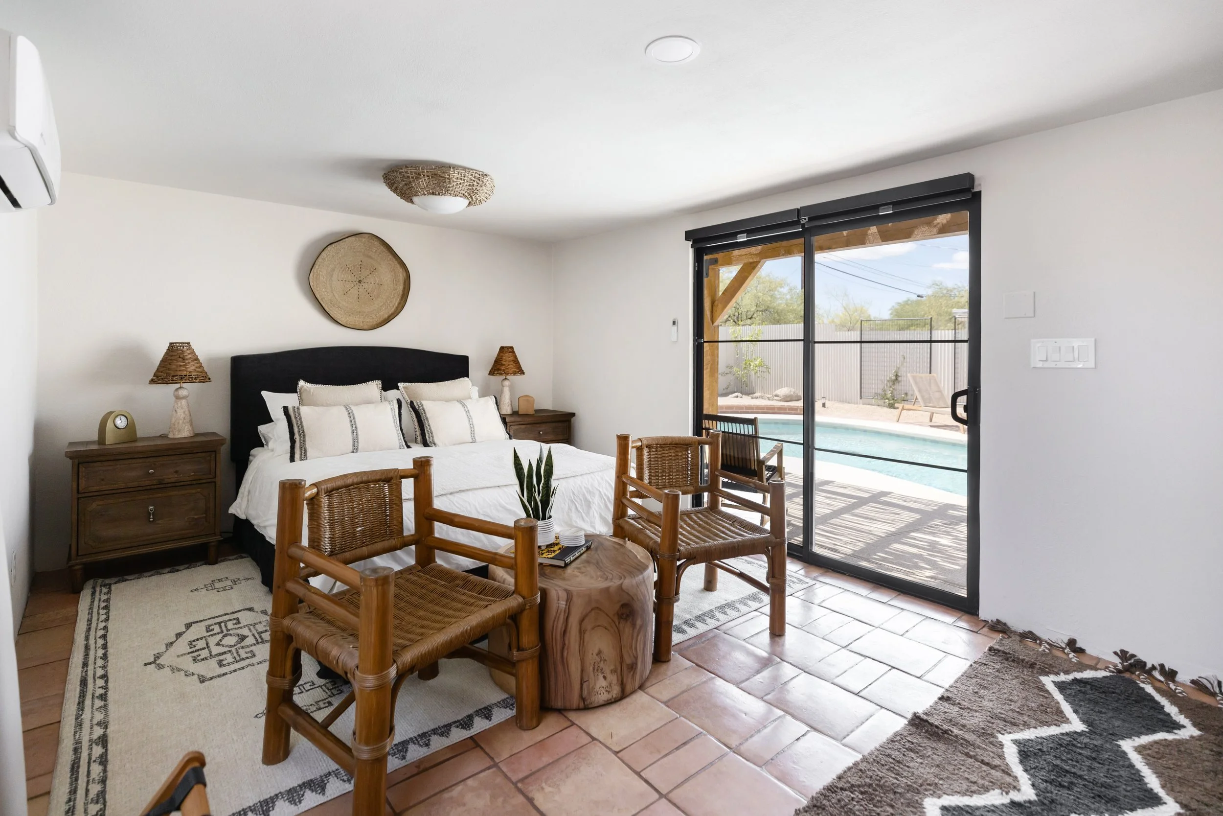 A calm and comfortable bedroom retreat designed to give guests a private escape within this Tucson backyard oasis.