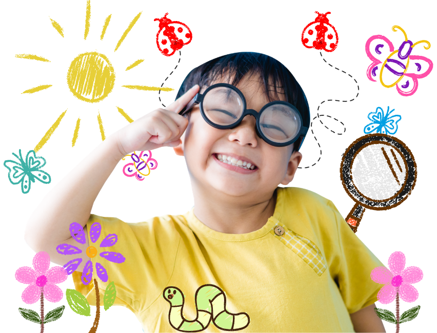 A little boy with his finger to his head smiling with bugs and flowers all around him | Orange Seeds Montessori St. Catharines daycare classroom