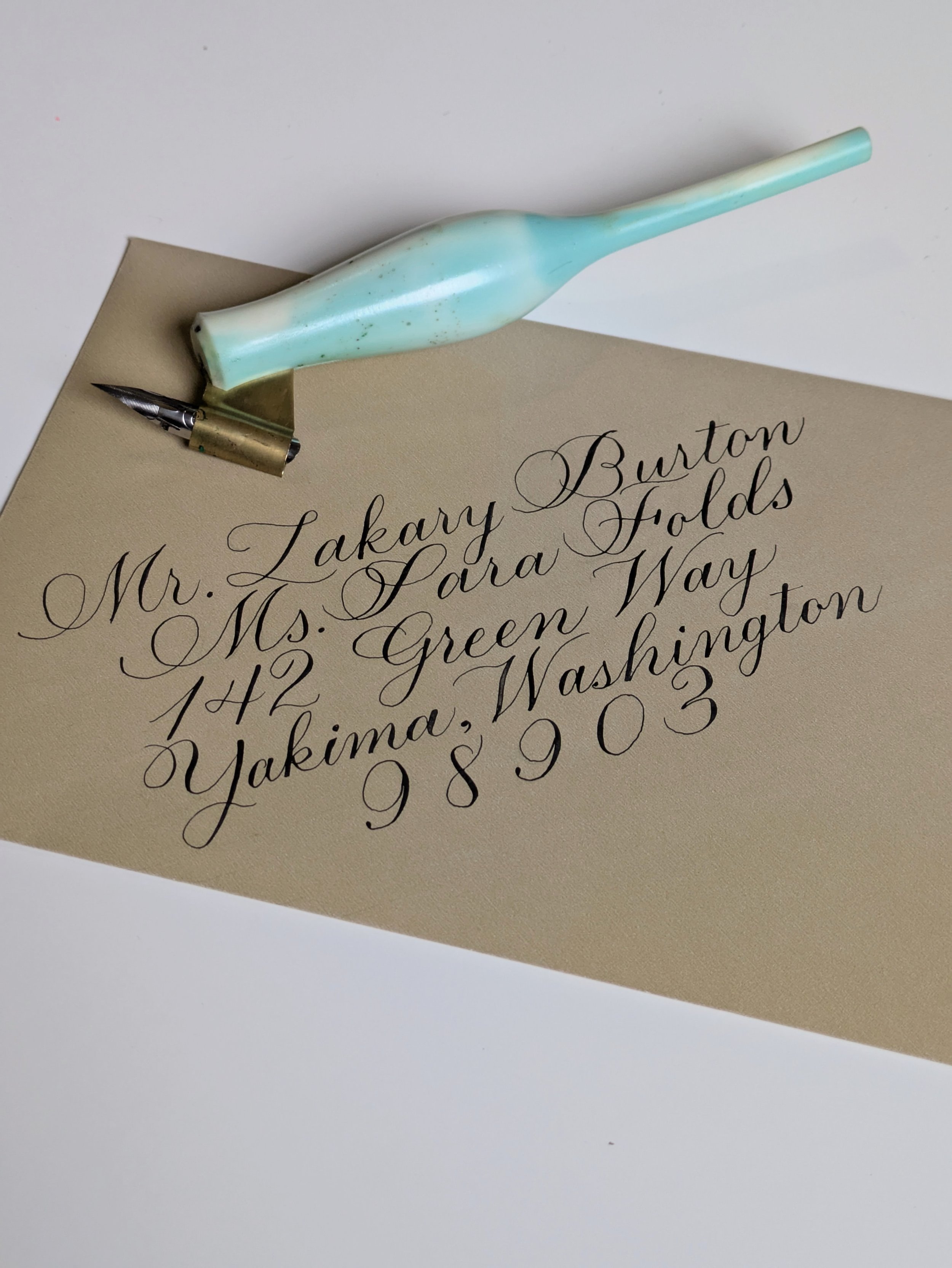 flourished copperplate calligraphy addressed envelope on a diagonal