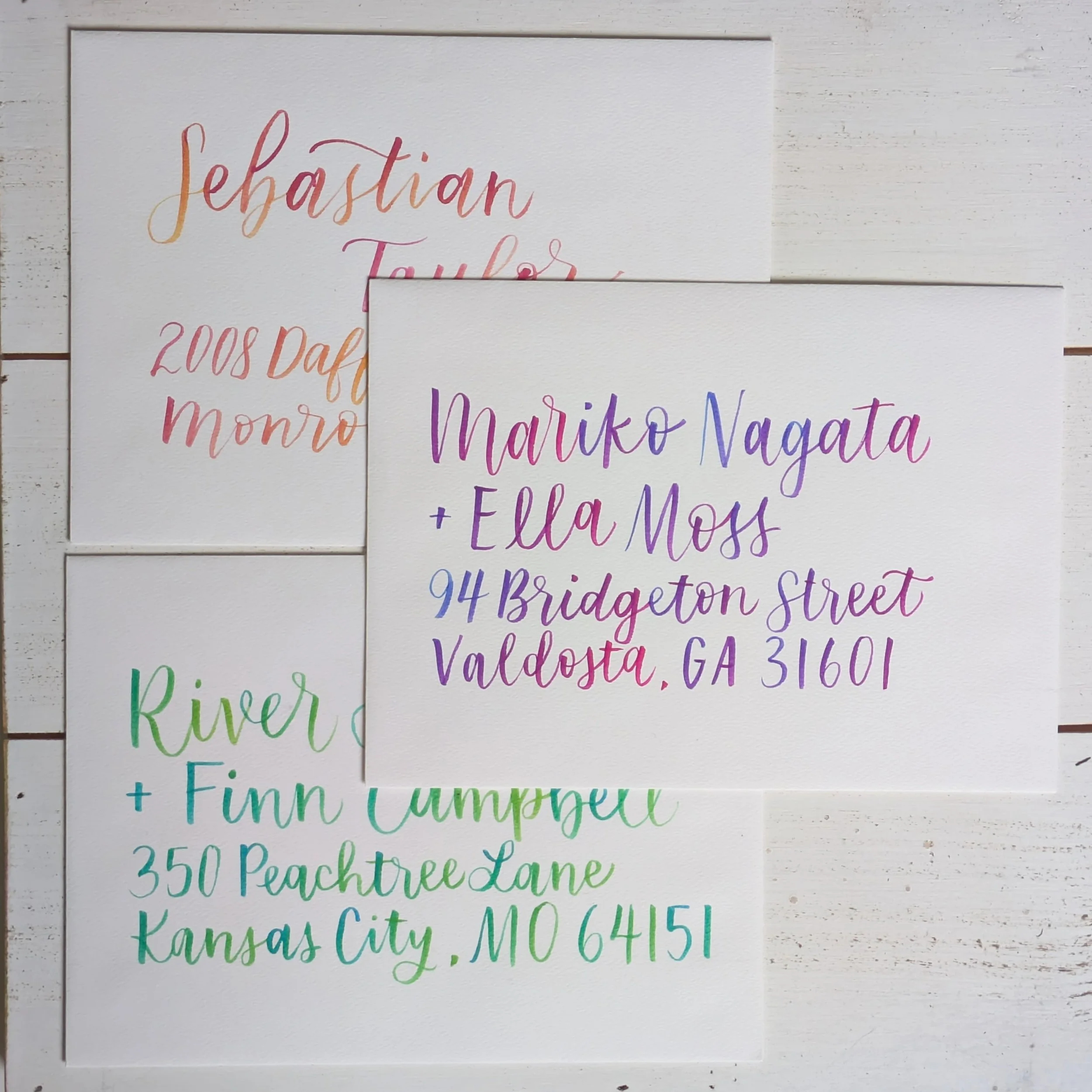 3 envelopes with colorful ombre brush lettering