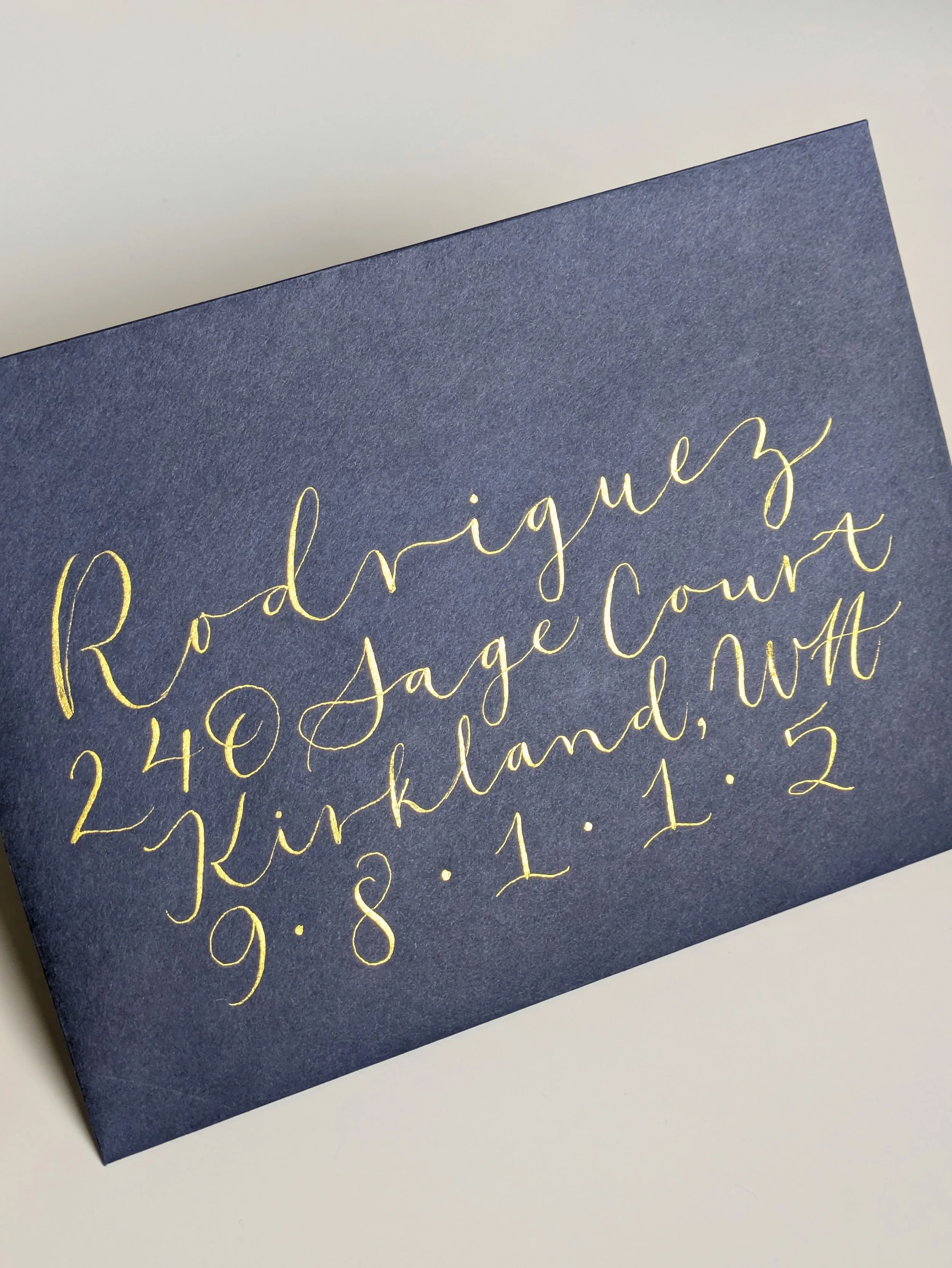 flowy gold modern calligraphy addressed envelope