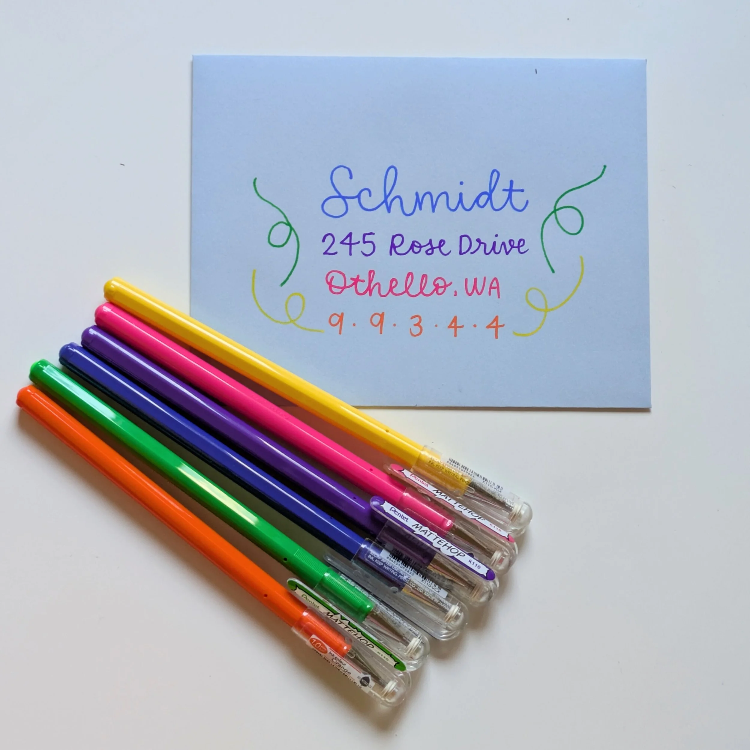 calligraphy addressed envelope with colorful confetti