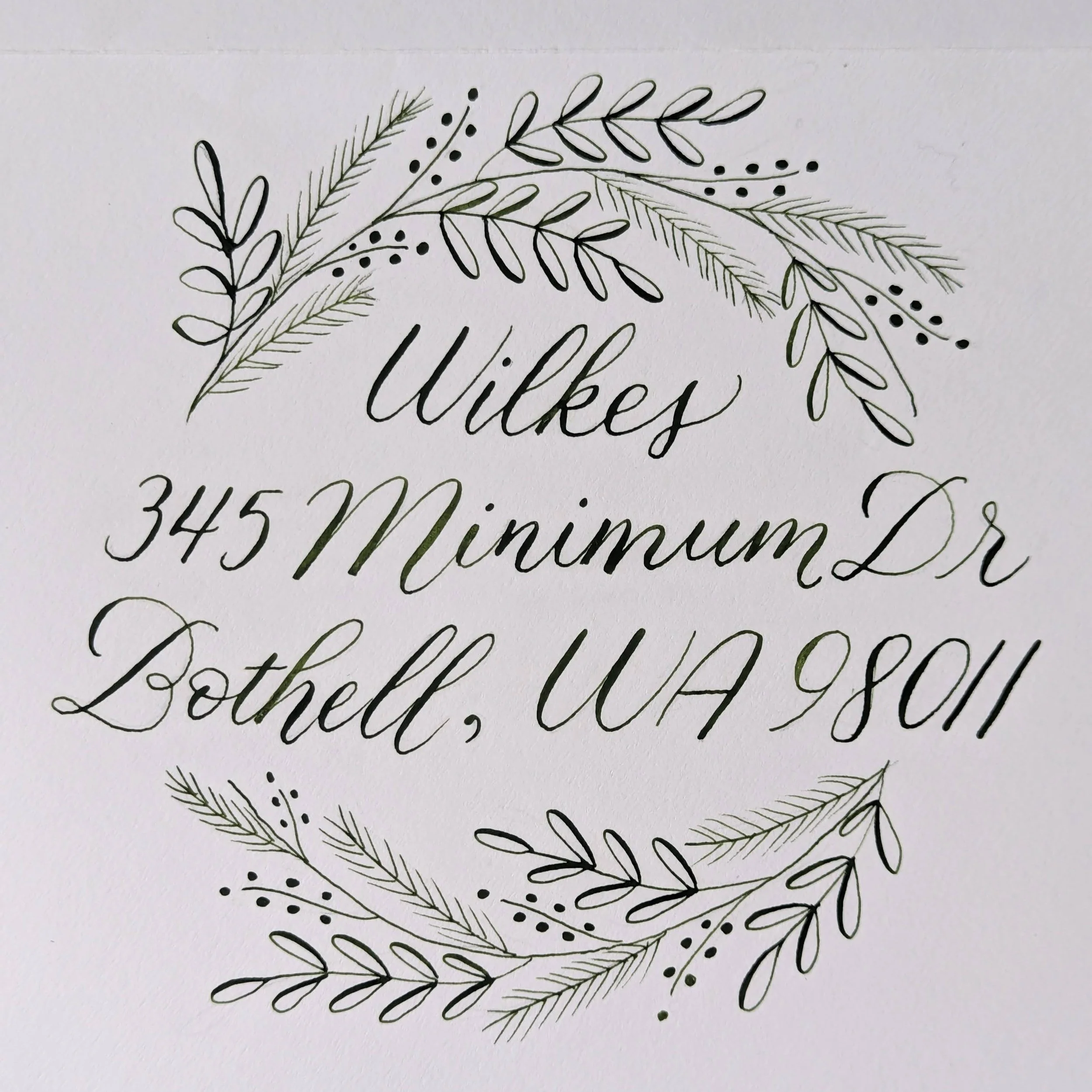 calligraphy addressed envelope with botanical wreath