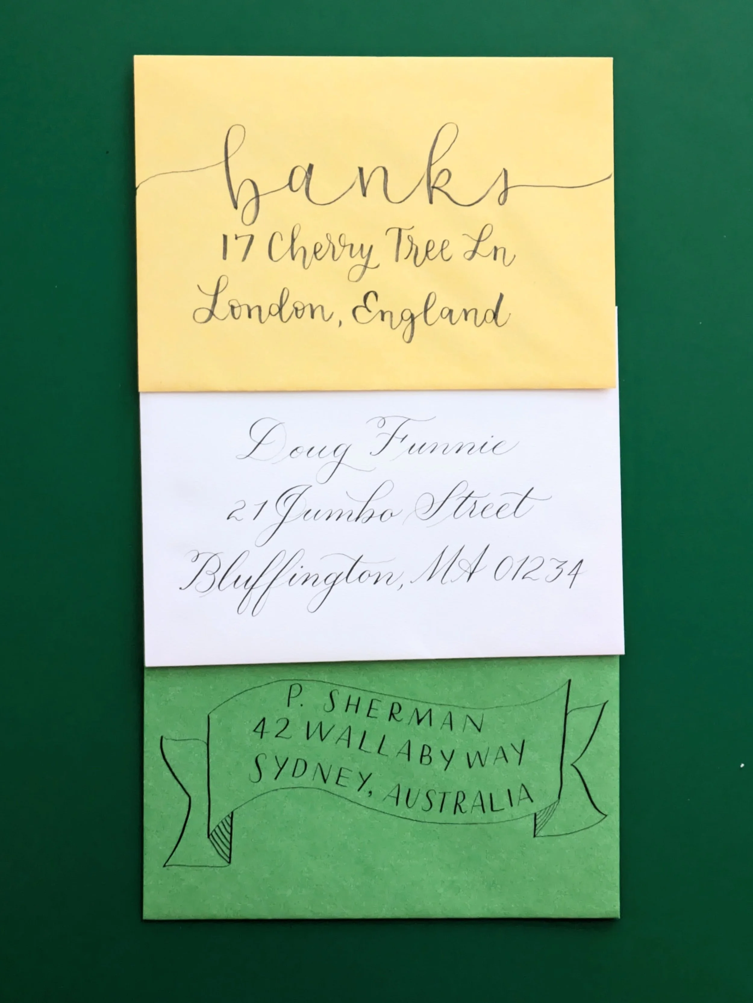 three envelopes addressed with various calligraphy styles