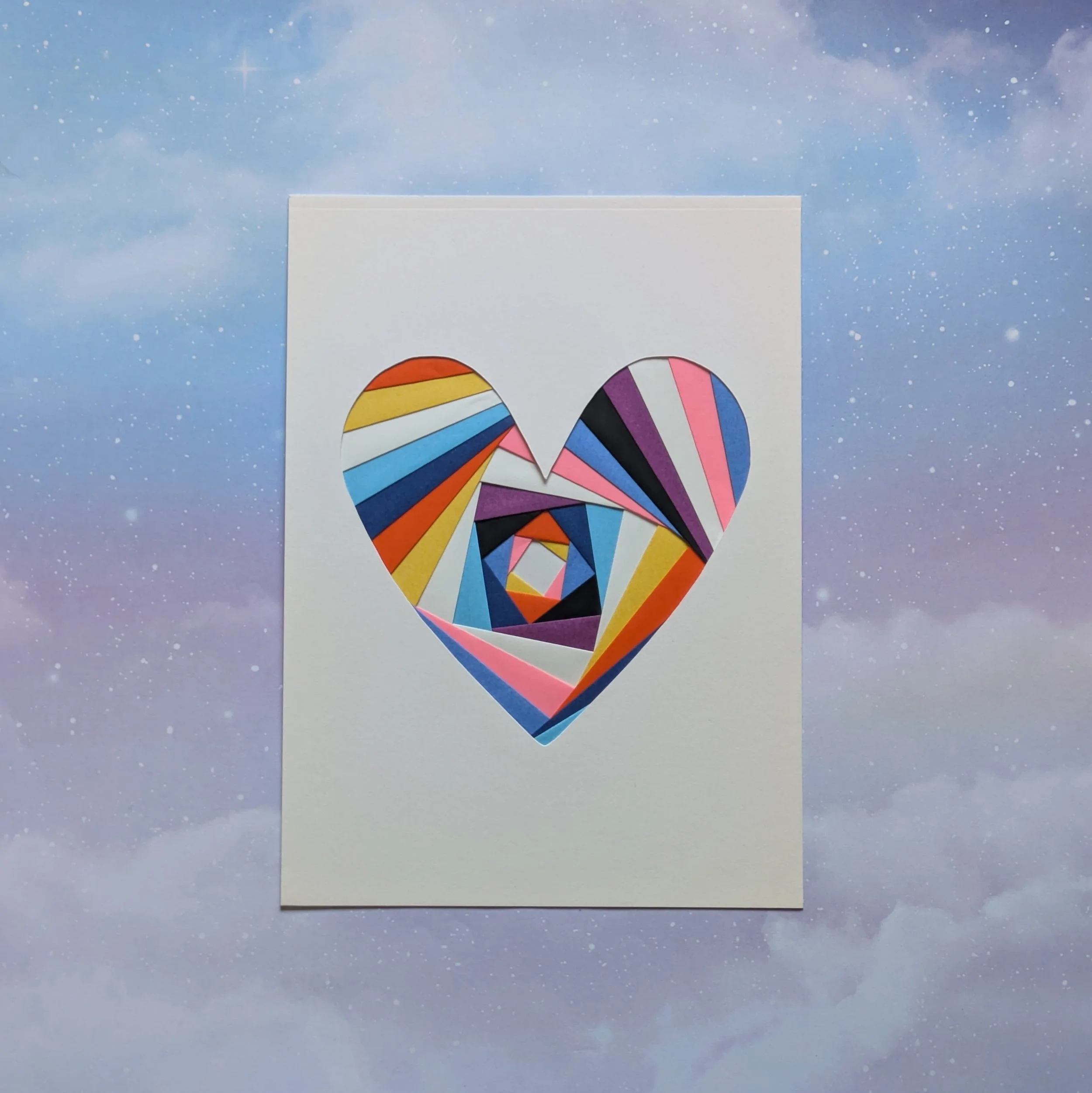 iris folded heart card in aroace and genderfluid pride flag colors