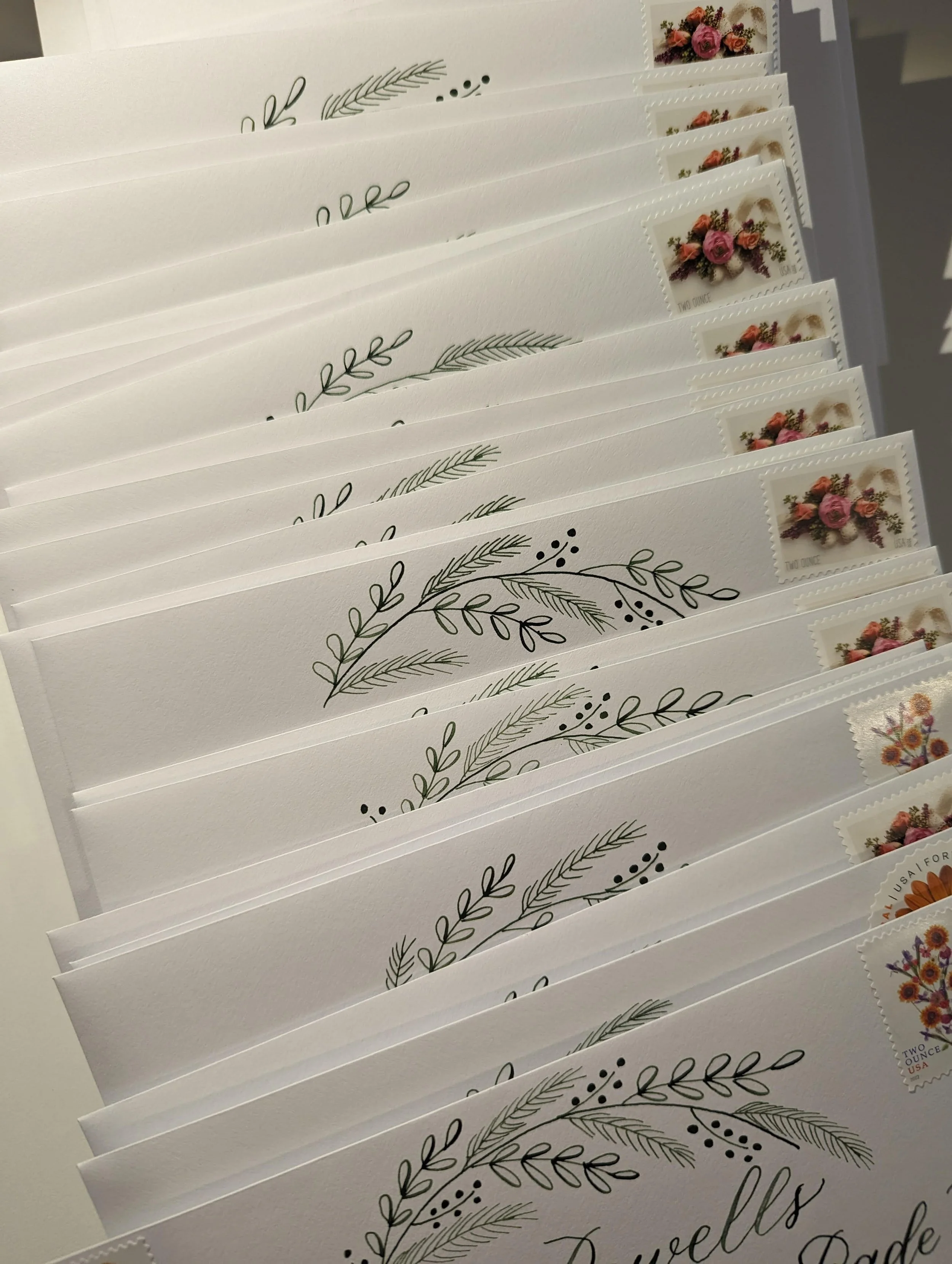 calligraphy addressed envelopes with botanical wreath