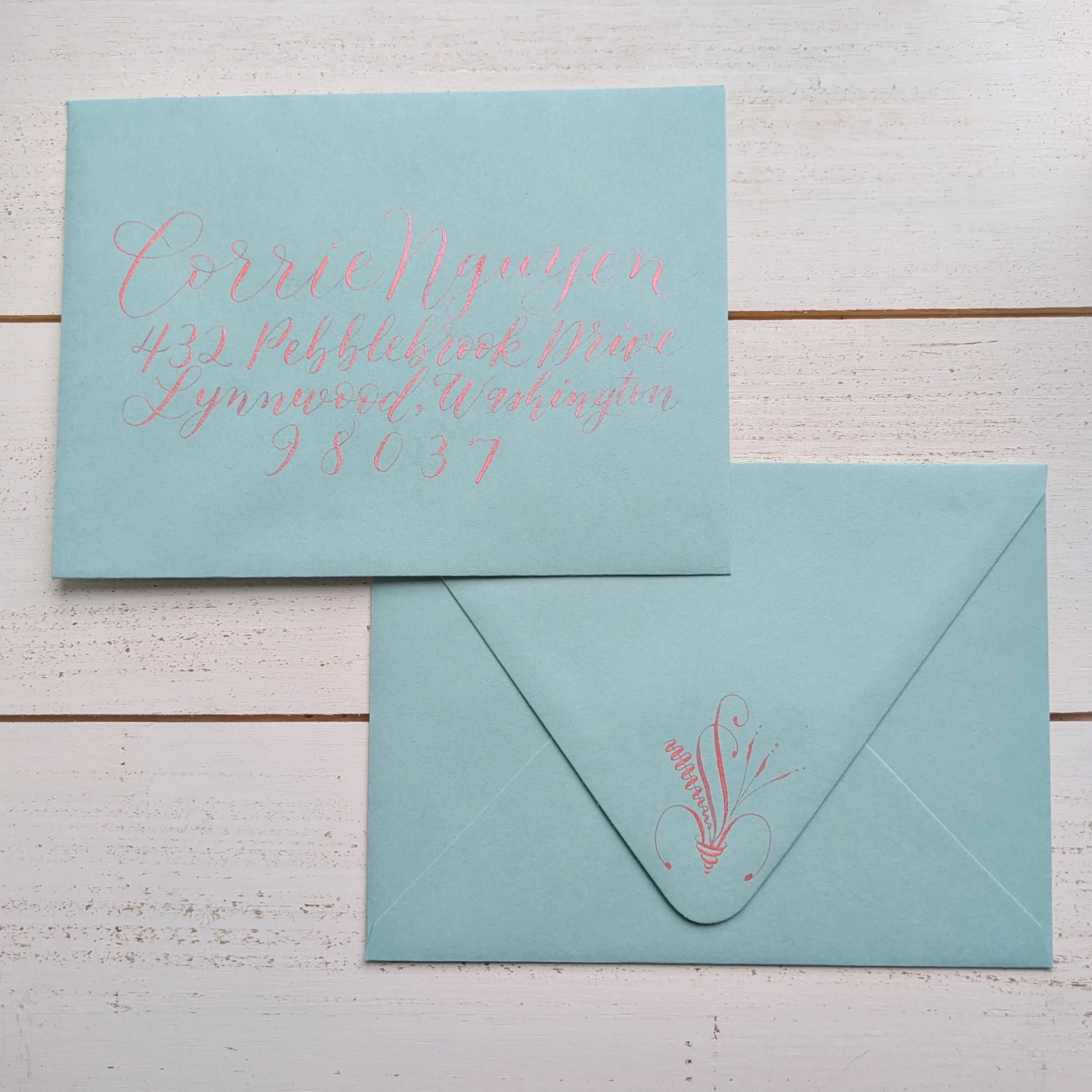 calligraphy addressed envelope with flourished details on back
