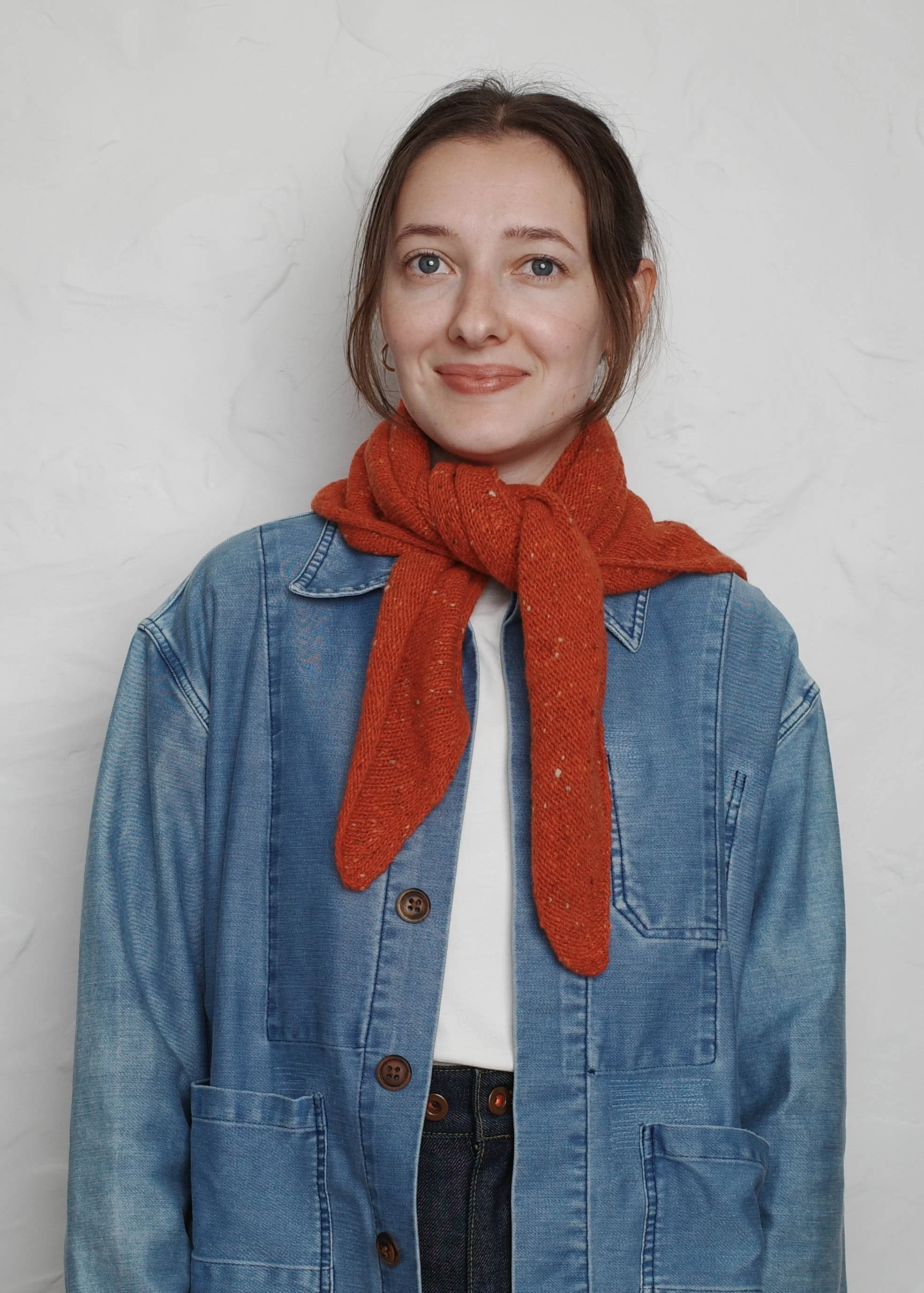 XL Knit Bandana in Lobster Red, tied as a neckerchief over a denim jacket