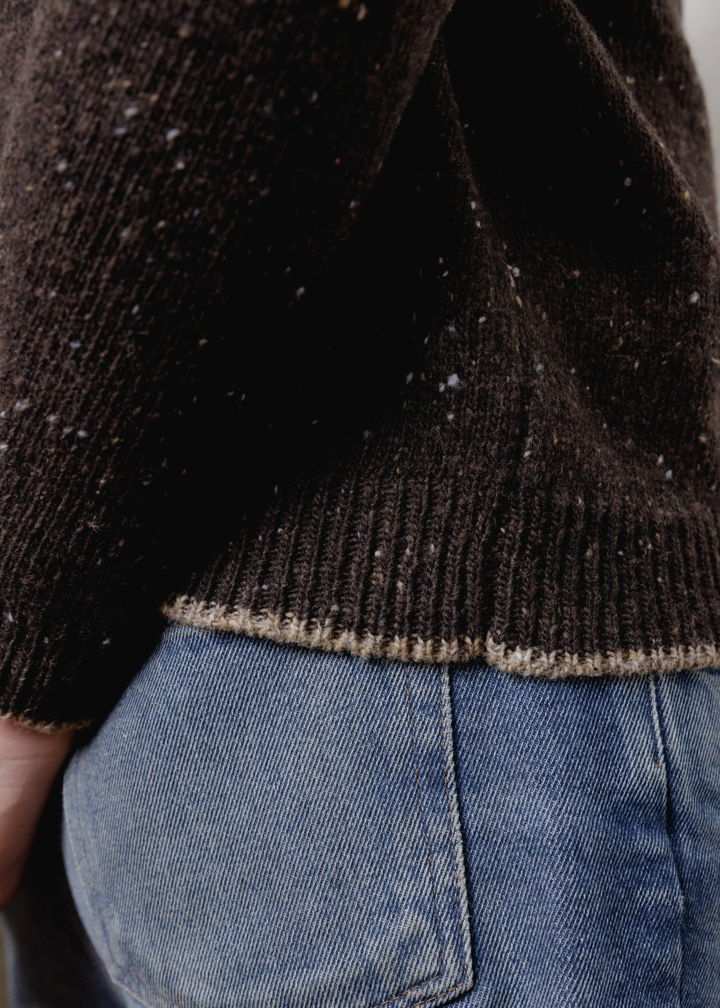 Everyday Raglan sweater in Chocolate, close-up of the ribbed hem with contrast edge