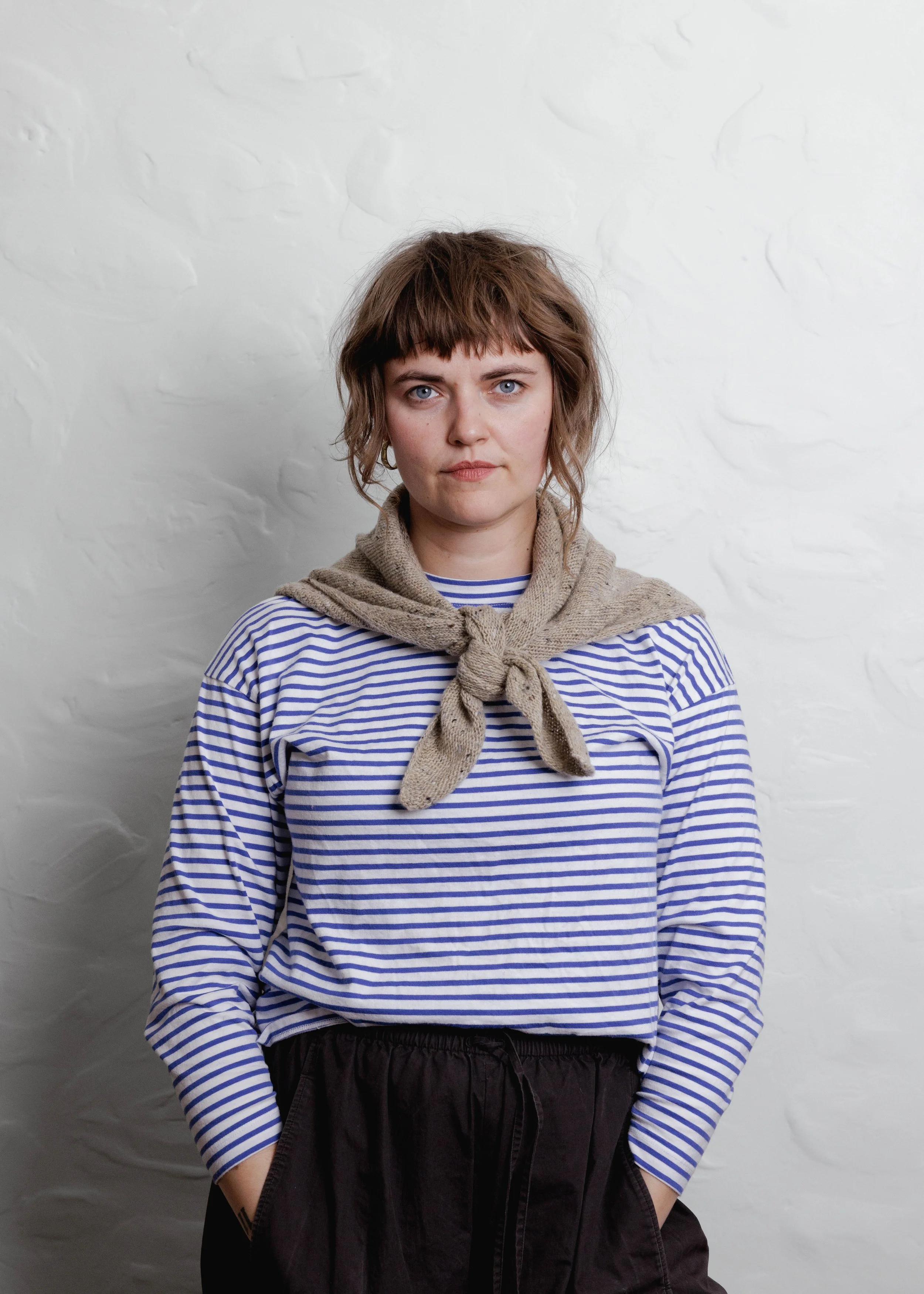 XL Knit Bandana in Oat, tied as a neckerchief with a striped top