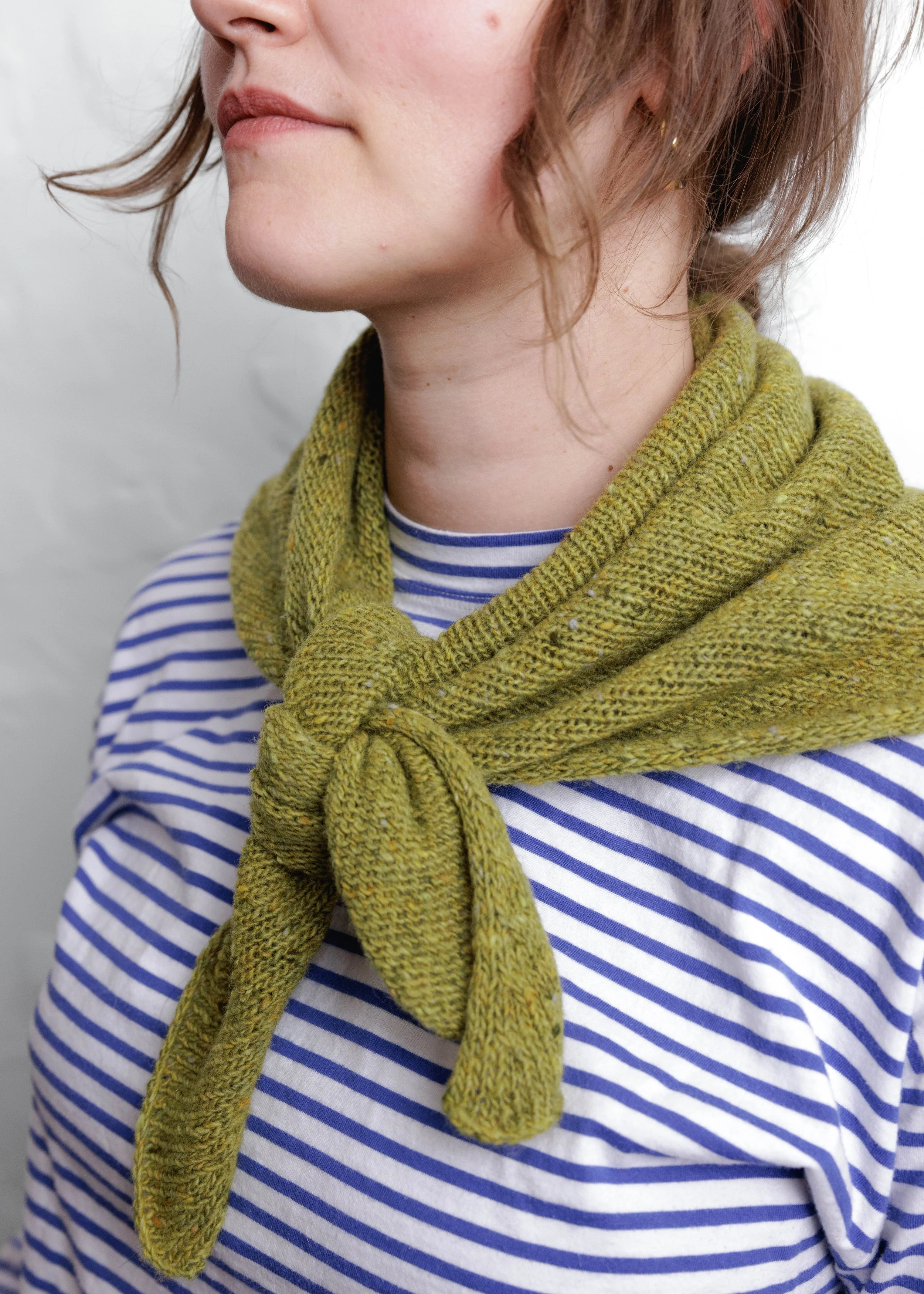 XL Knit Bandana in Lime Green, close-up of the knot, worn with a striped top