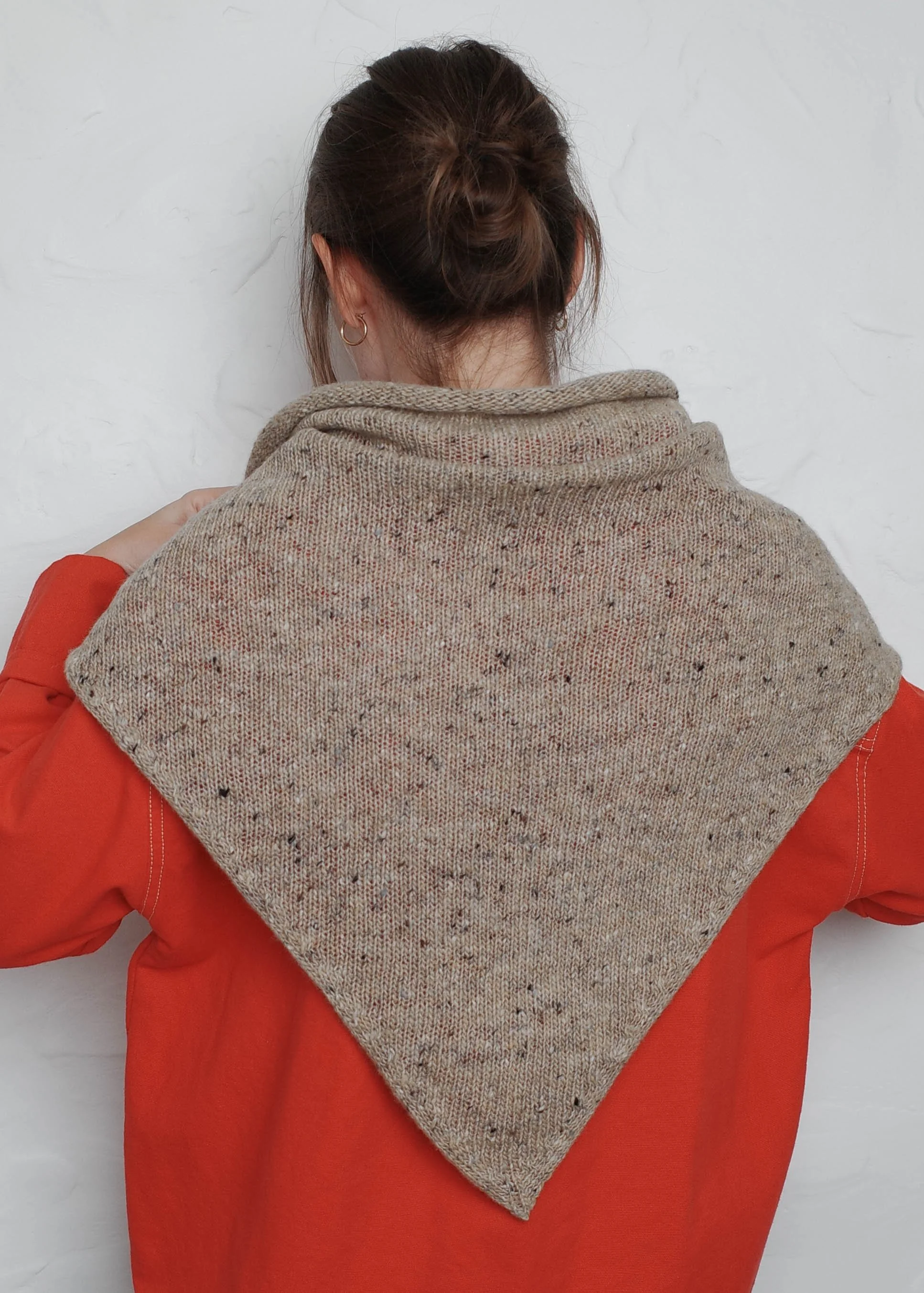 XL Knit Bandana in Oat, draped over a red sweater, back view
