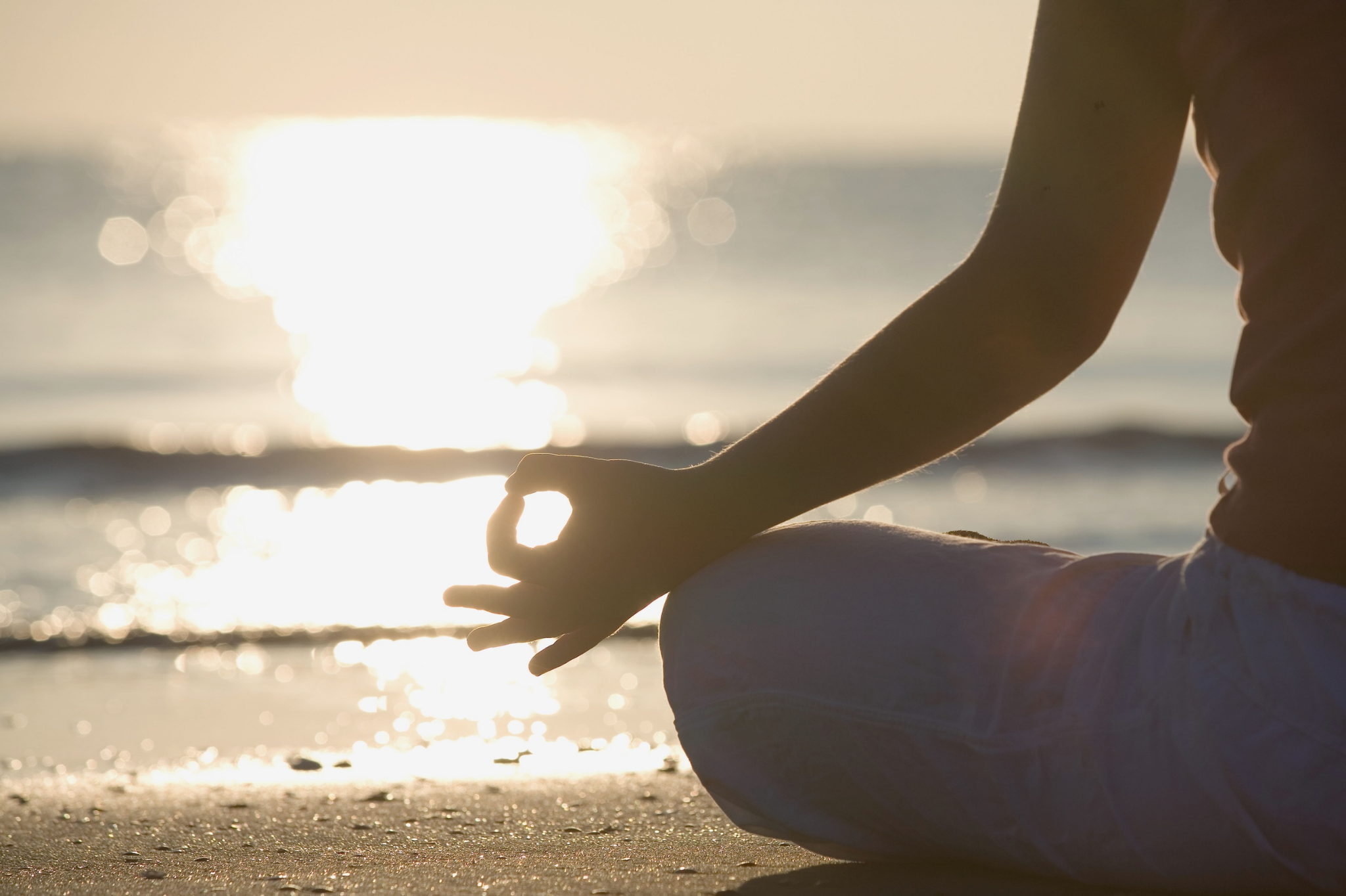 Person meditating by the water, representing healing and clarity when outgrowing your partner in Portland, Oregon and Seattle, Washington.