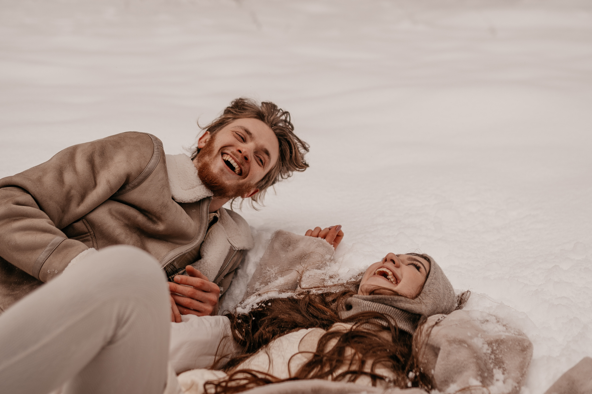 A couple laughs joyfully in the snow, a picture of the freedom and connection possible when you heal. Unlearning the Fawn response can bring authentic joy. Our Advice on Relationships in Portland supports clients in zip codes 97035 and 97229.