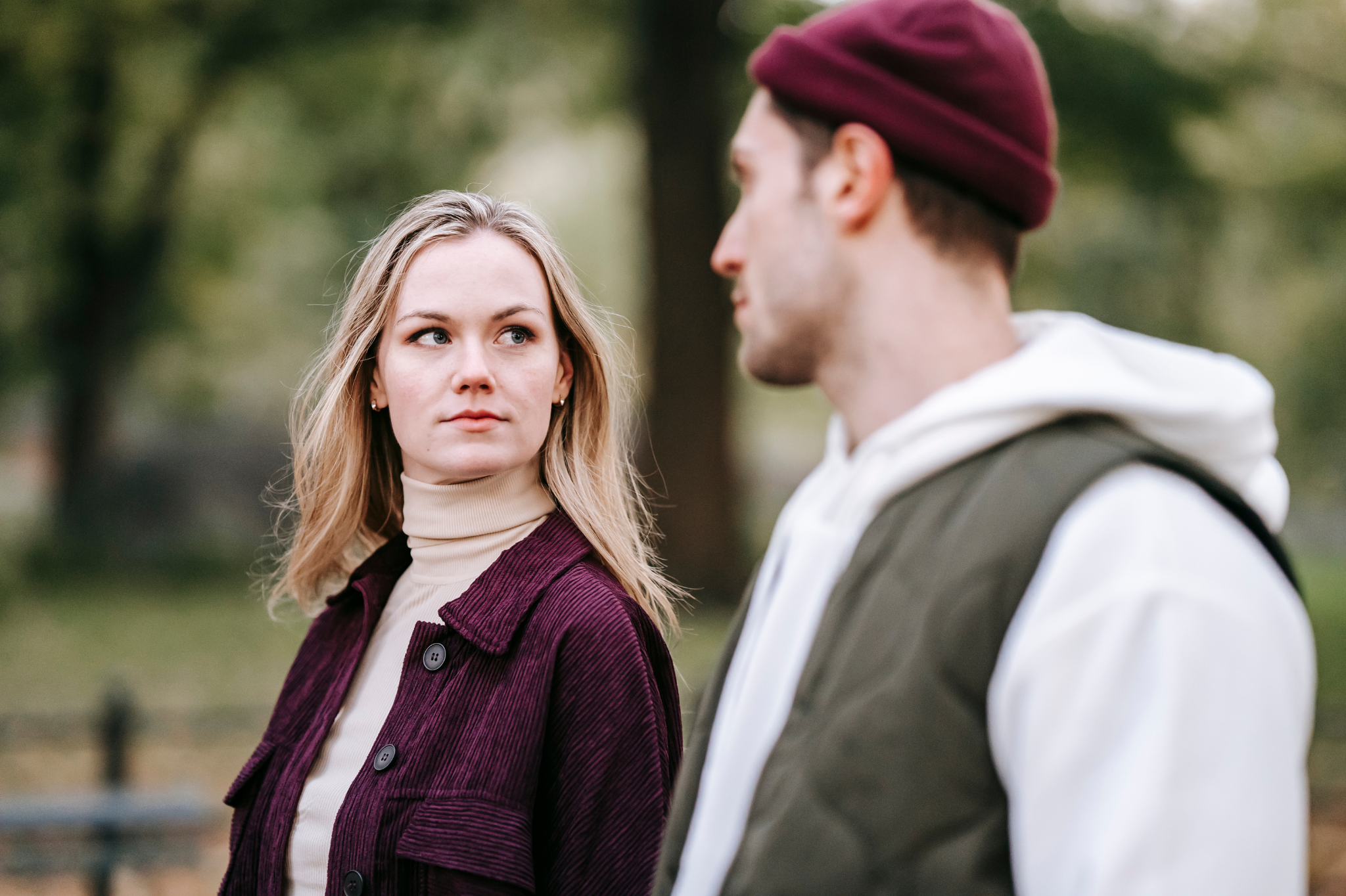 A thoughtful couple converses outdoors, reflecting the delicate infidelity recovery process. We help partners navigate complex relationship challenges in the 97035 zip code.