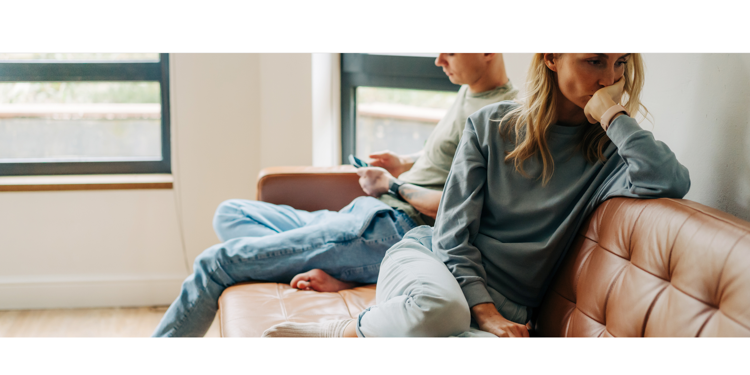 Couple ignoring each other on a couch. Struggling to maintain a healthy relationship? Couples counseling in Portland, OR can help you reconnect. Learn more by exploring Spark Relational Counseling.