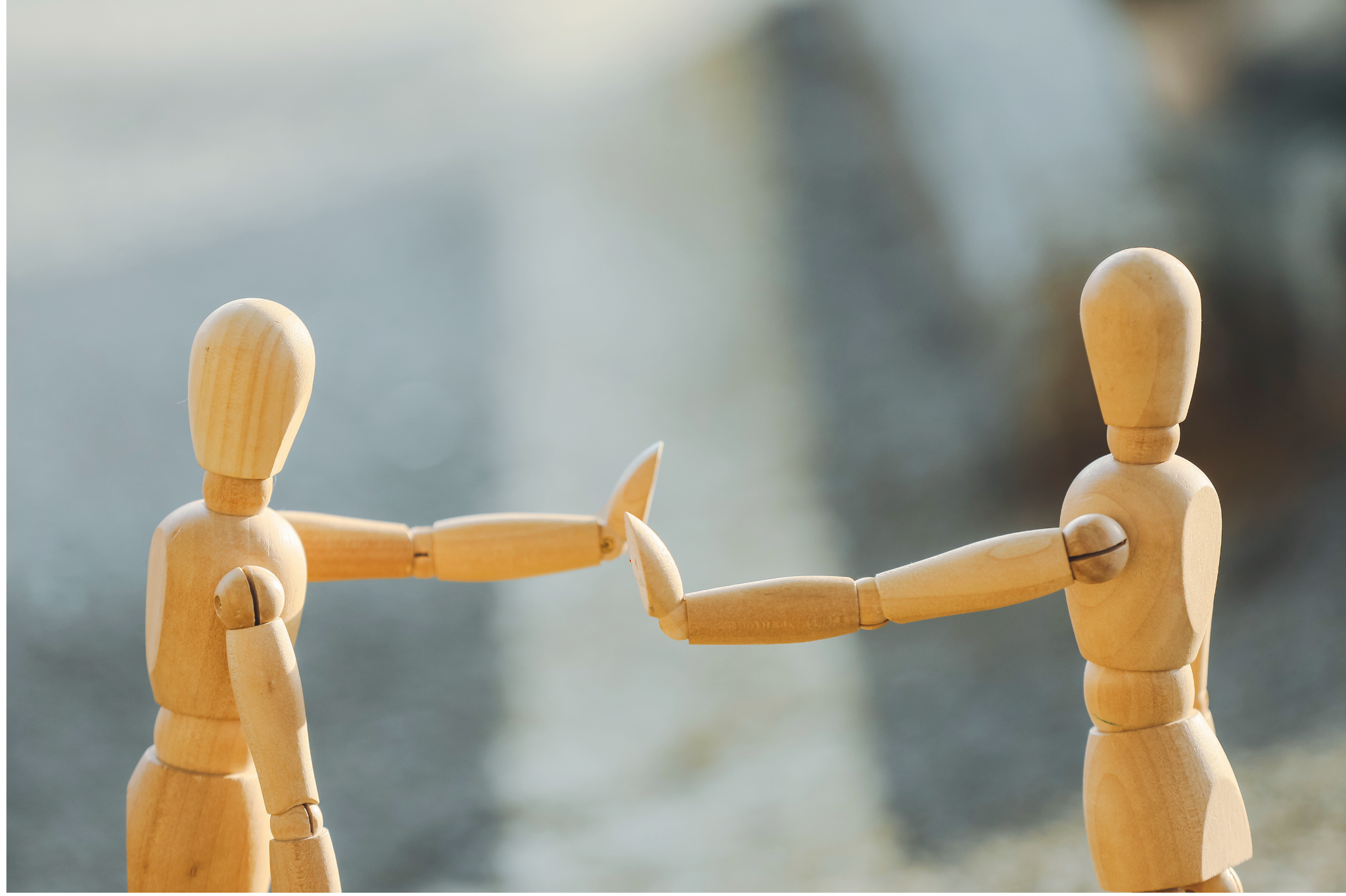 Two wooden figures reach out, symbolizing the attempt to connect while navigating the Fawn response. Advice on Relationships in Portland, Oregon, helps you set healthy boundaries. We serve clients in zip code 97035,97229,97214,97210