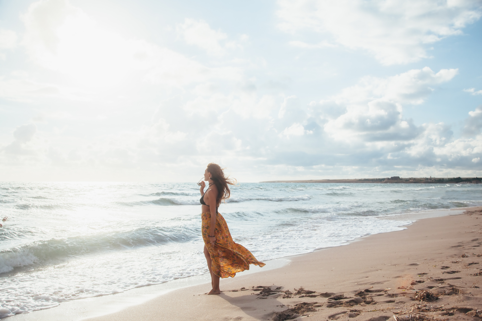 A woman stands alone on a sunlit beach, a serene image of finding clarity. Learning not to engage in trauma dumping is a step toward peace. Our advice on relationships in Lake Oswego, Oregon can help you heal. We serve the 97035 zip code.