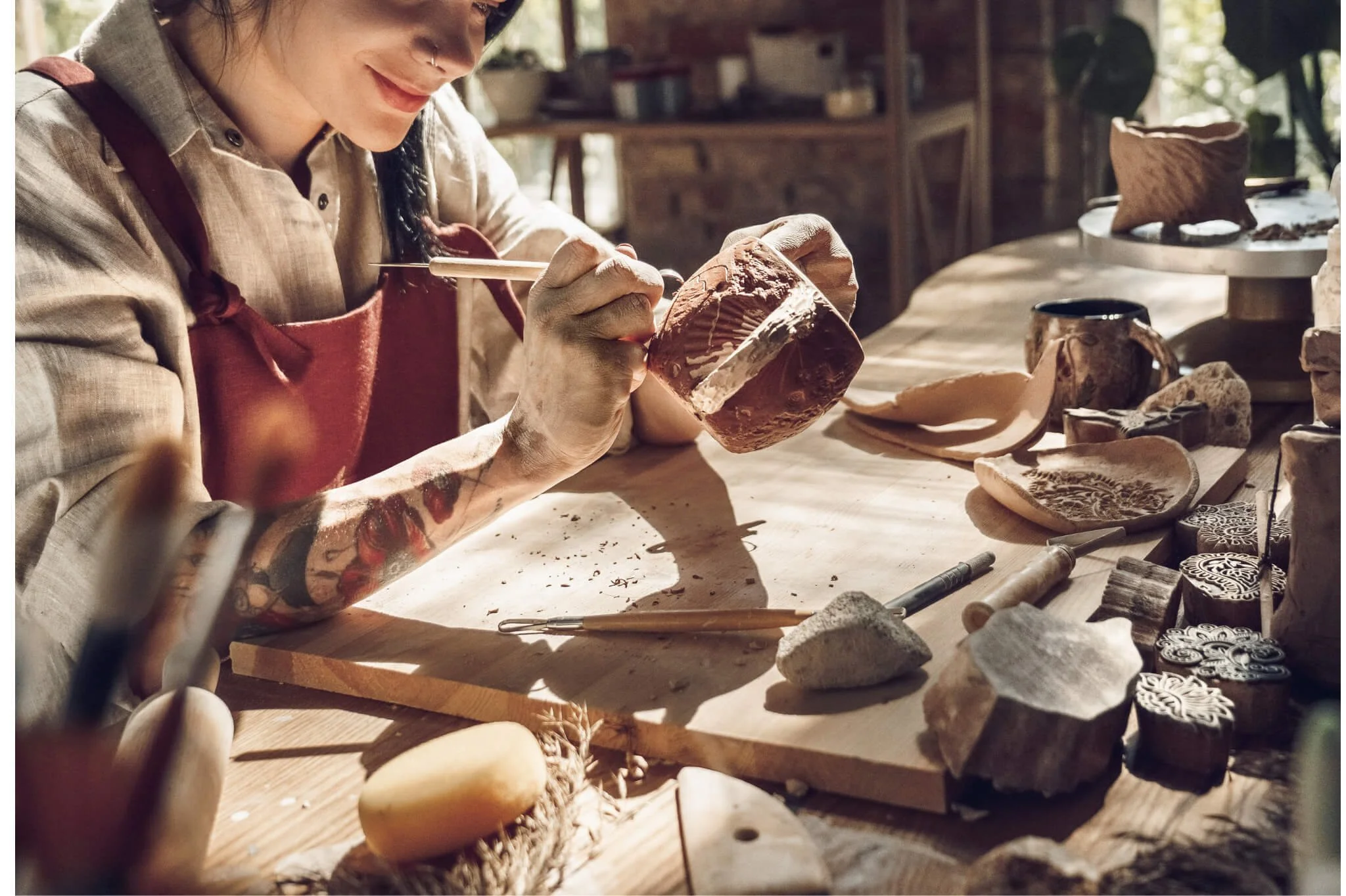 An individual working on a pottery piece in workshop. Burnout therapy in Seattle, WA can help with job, relationship & other forms of burnout. Learn more here!