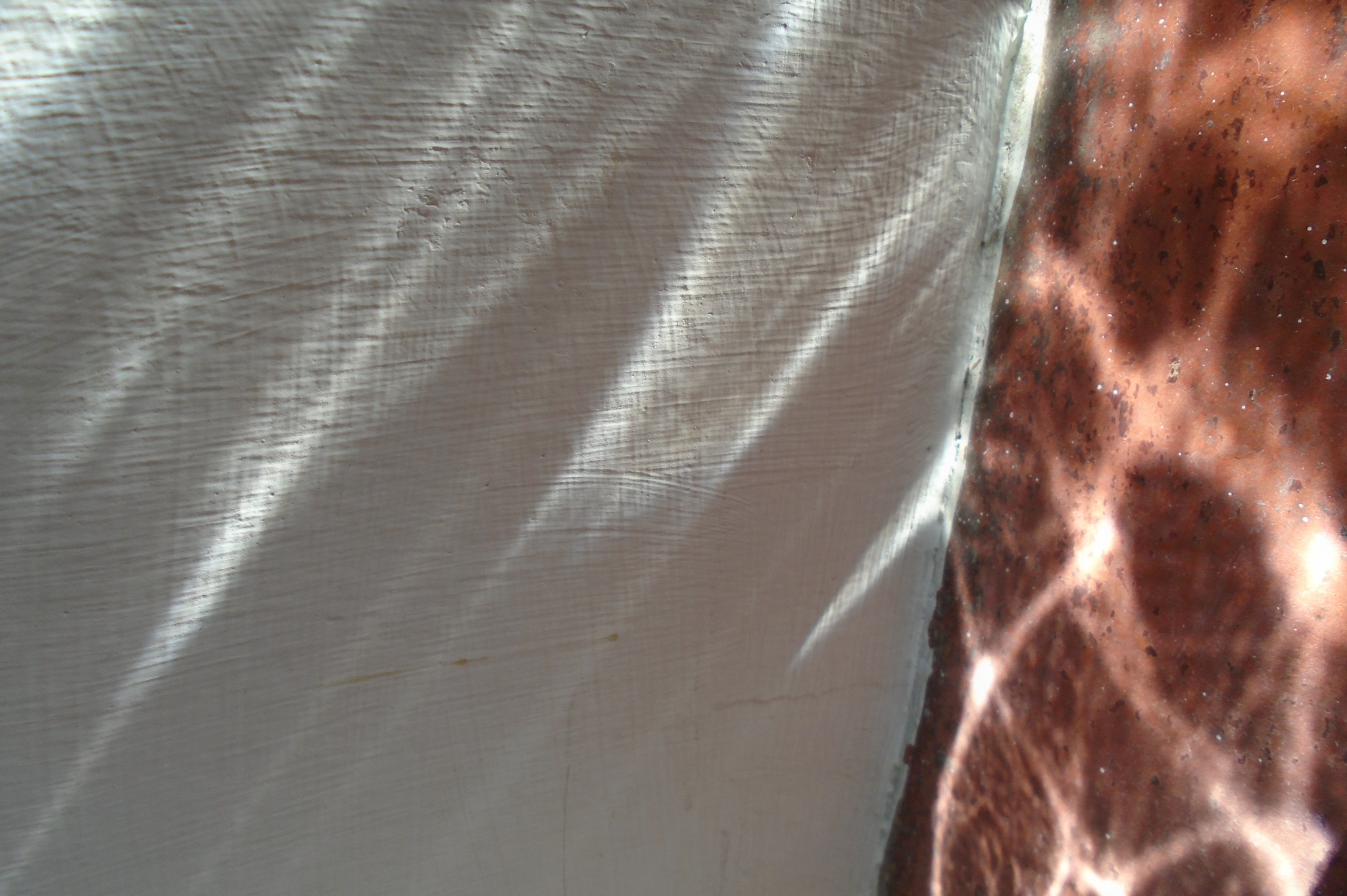 Light and shadow converge on textured surfaces, symbolizing healing after betrayal and the infidelity recovery process. Supporting couples in the 97035 zip code.