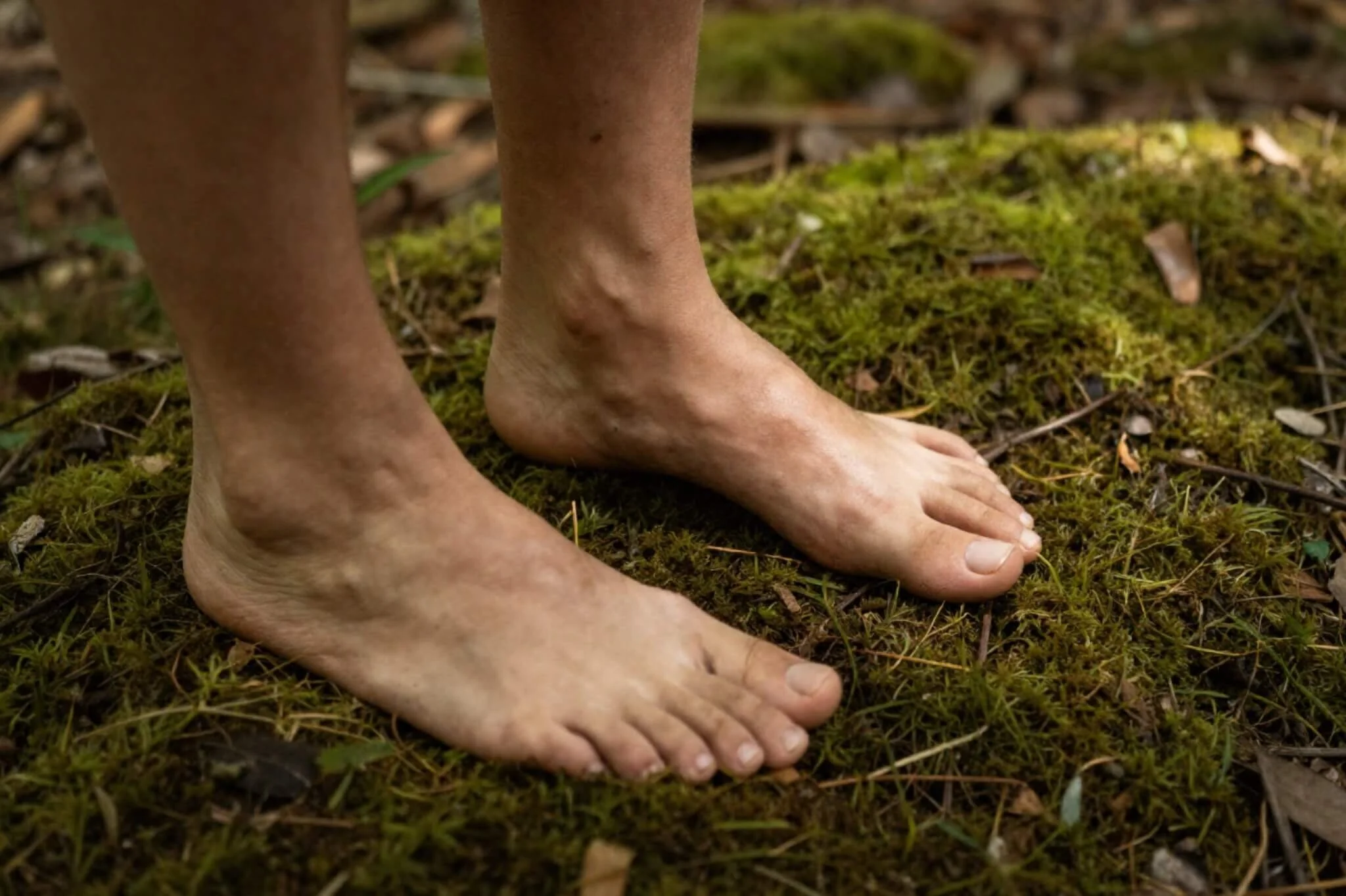 Bare feet standing on green moss. Representing how high functioning depression. Learn how burnout therapy in Seattle, WA can help with high functioning depression symptoms.