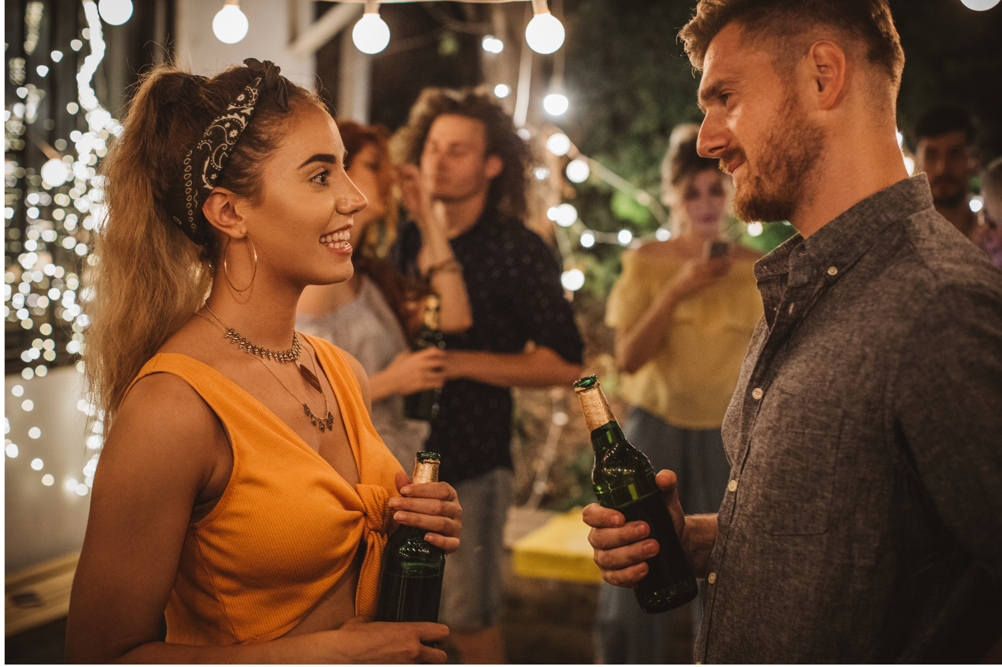 A man and woman talk and smile at an evening party, showing a moment of easy connection. Relationship anxiety can make these moments feel difficult. We help with anxiety in relationships for clients in Oregon, including zip code 97229.
