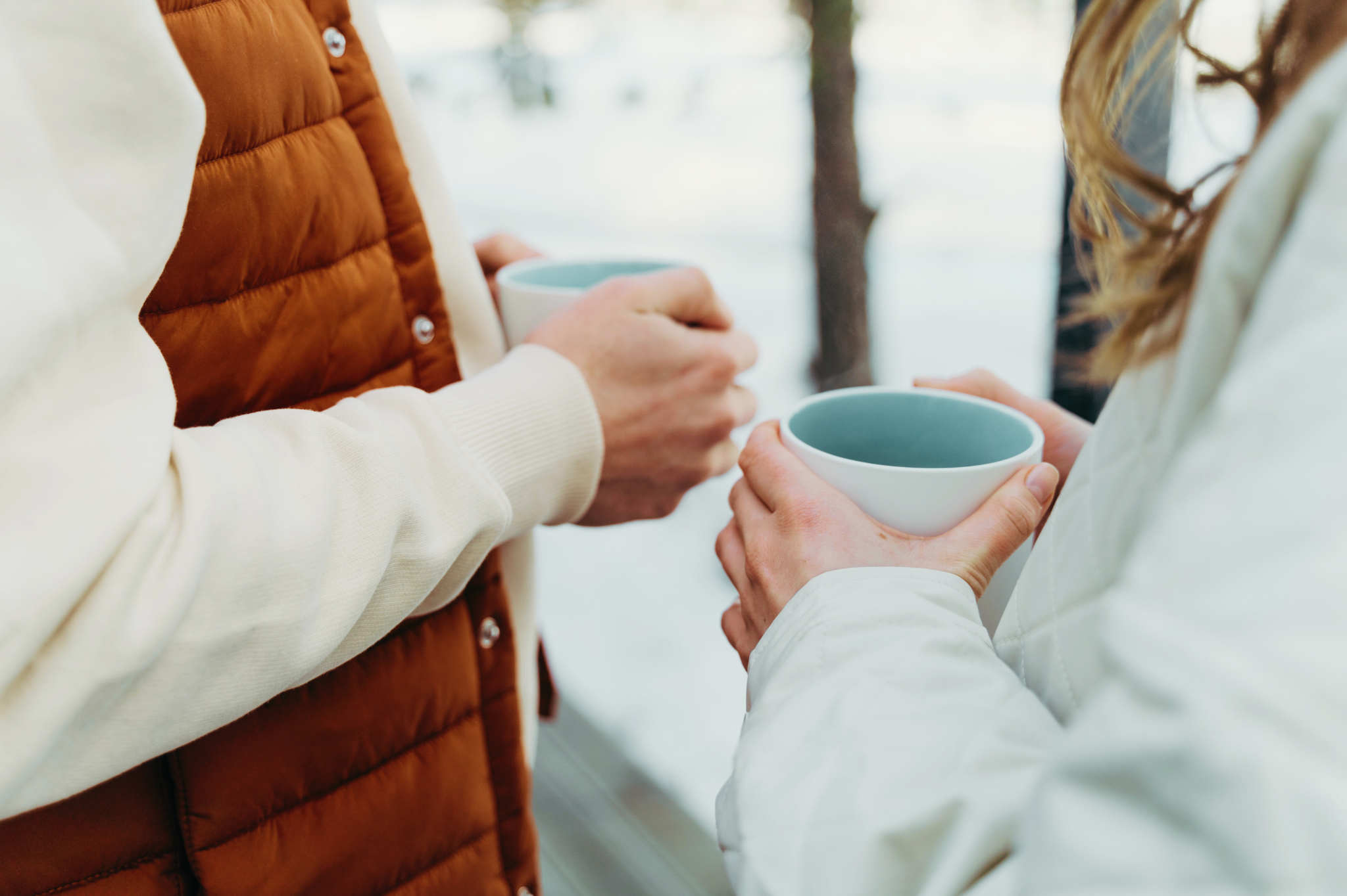Two individuals holding coffee mugs outside in the snow. Couples therapy in Portland, OR can help you break the conflict cycle. Reach out today to begin therapy.