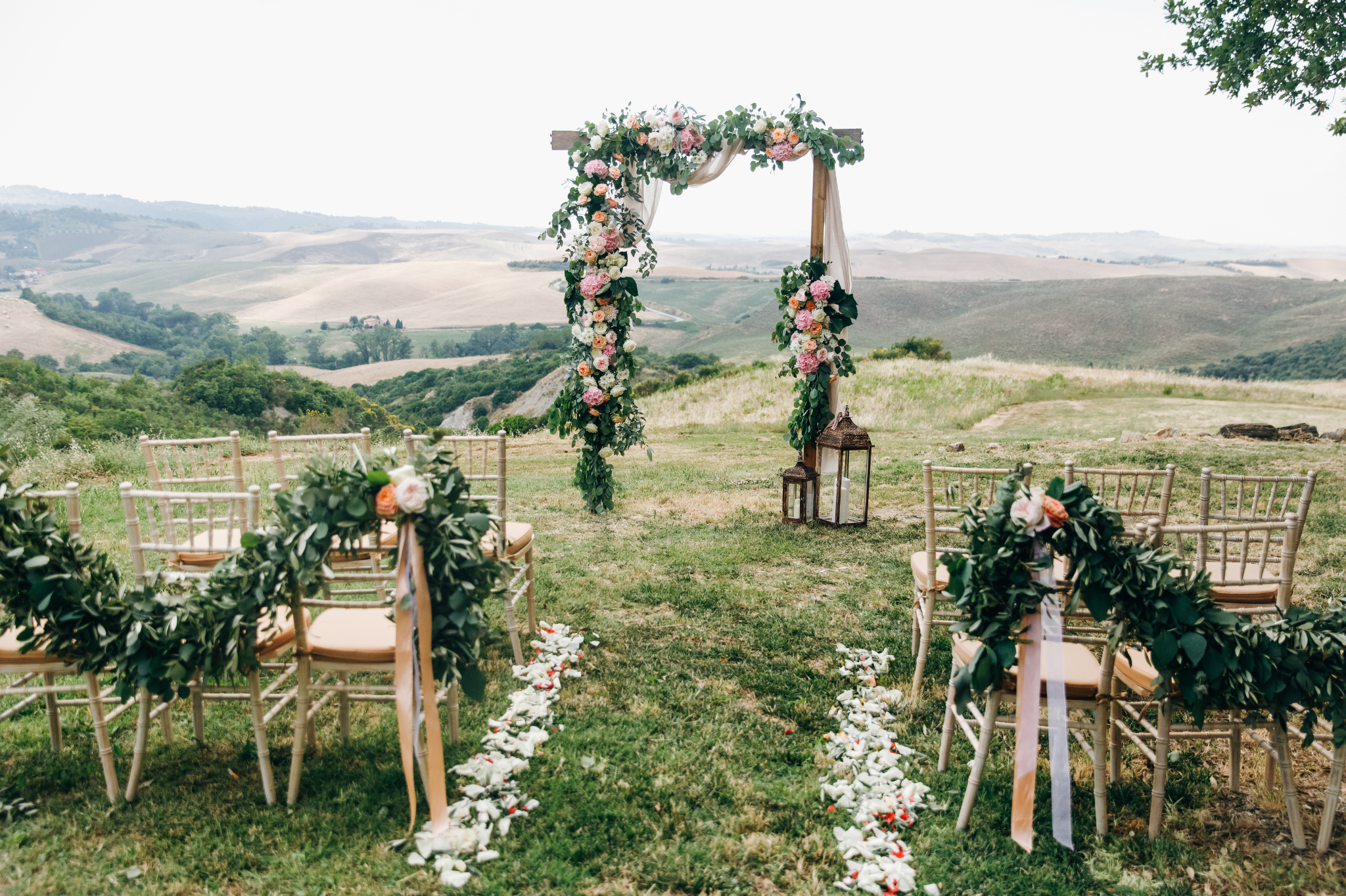 A beautifully arranged outdoor wedding ceremony in Seattle, Washington, showcasing a floral arch and aisle that symbolize milestones in relationships, including couples therapy, marriage counseling. 98004, 98006, 98109, 98121, 98052